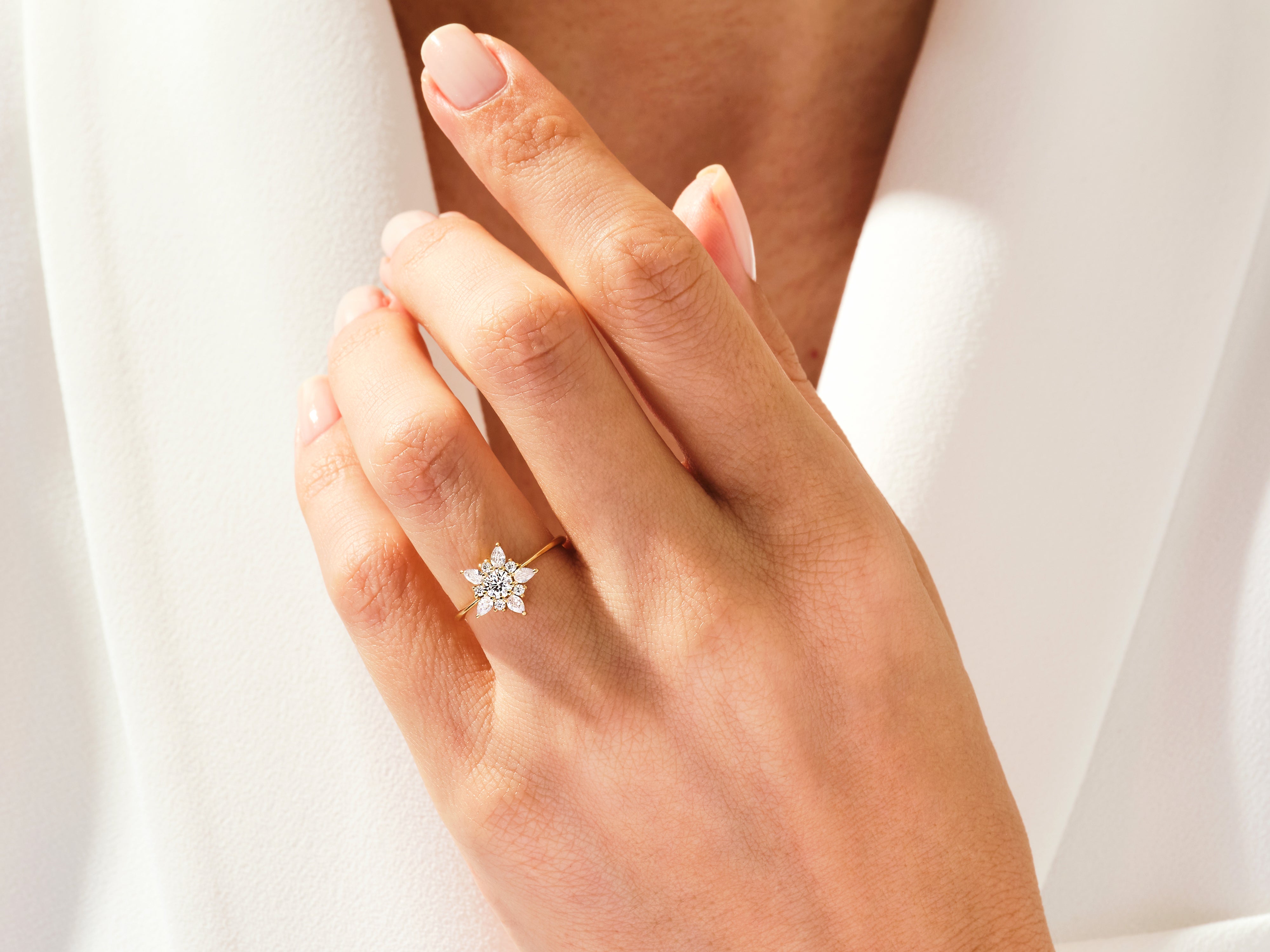Gold flower ring with diamonds on a hand