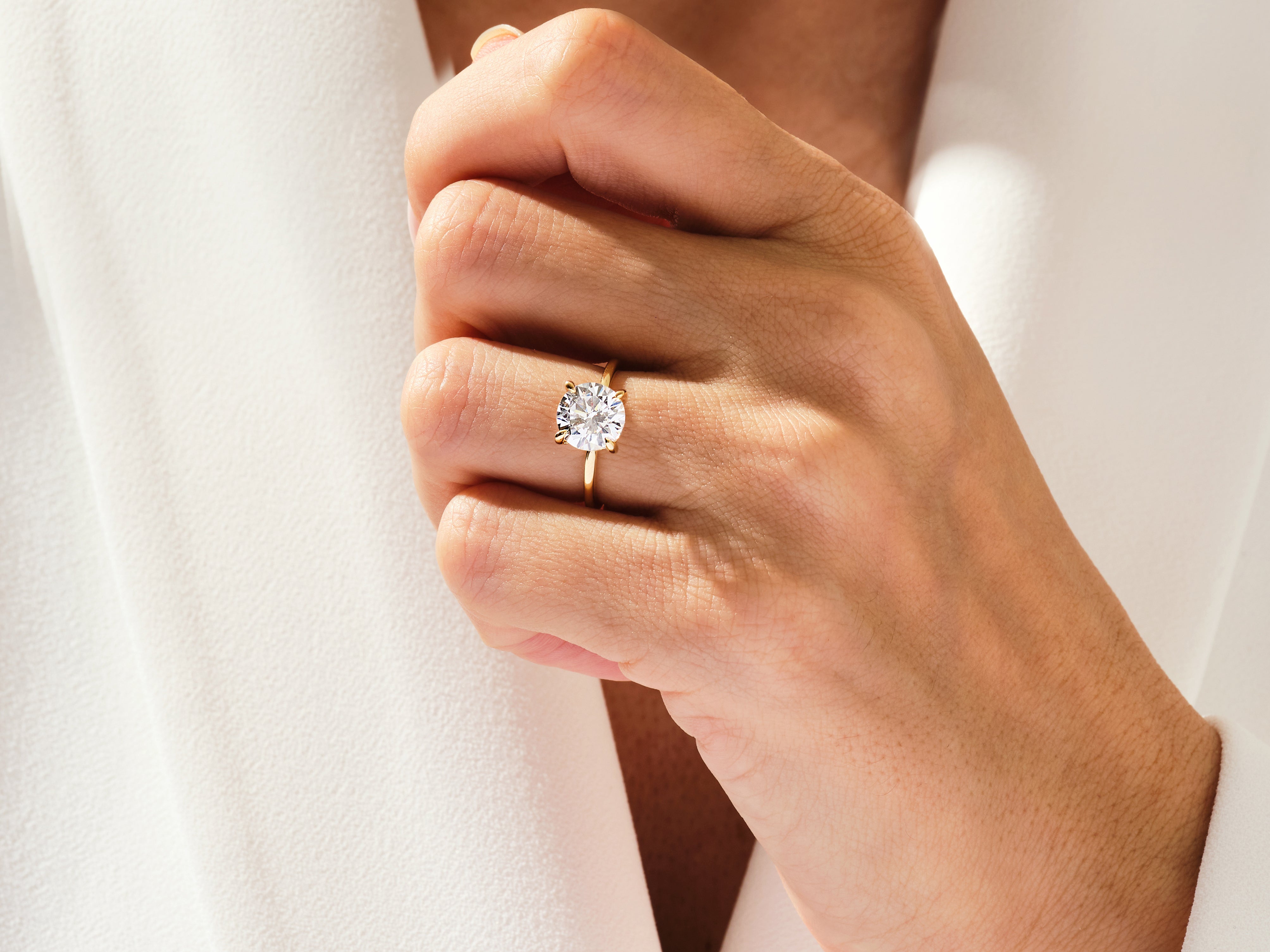 Diamond engagement ring on a woman's hand, fine jewelry