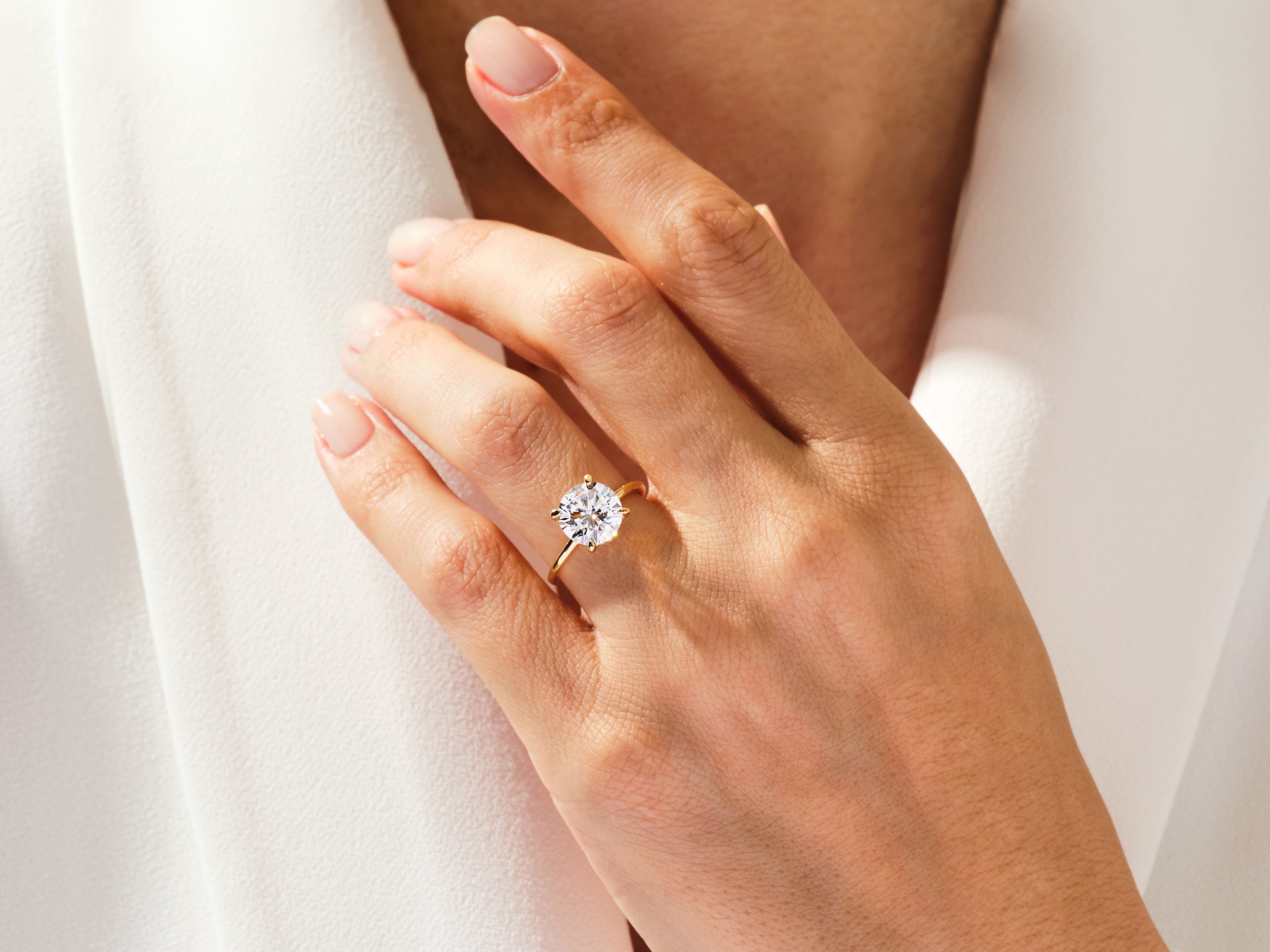 Diamond engagement ring on a woman's hand, fine jewelry