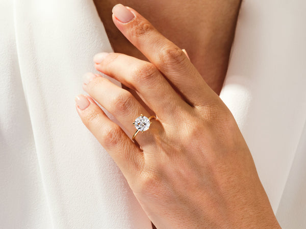 Diamond engagement ring on a woman's hand, fine jewelry
