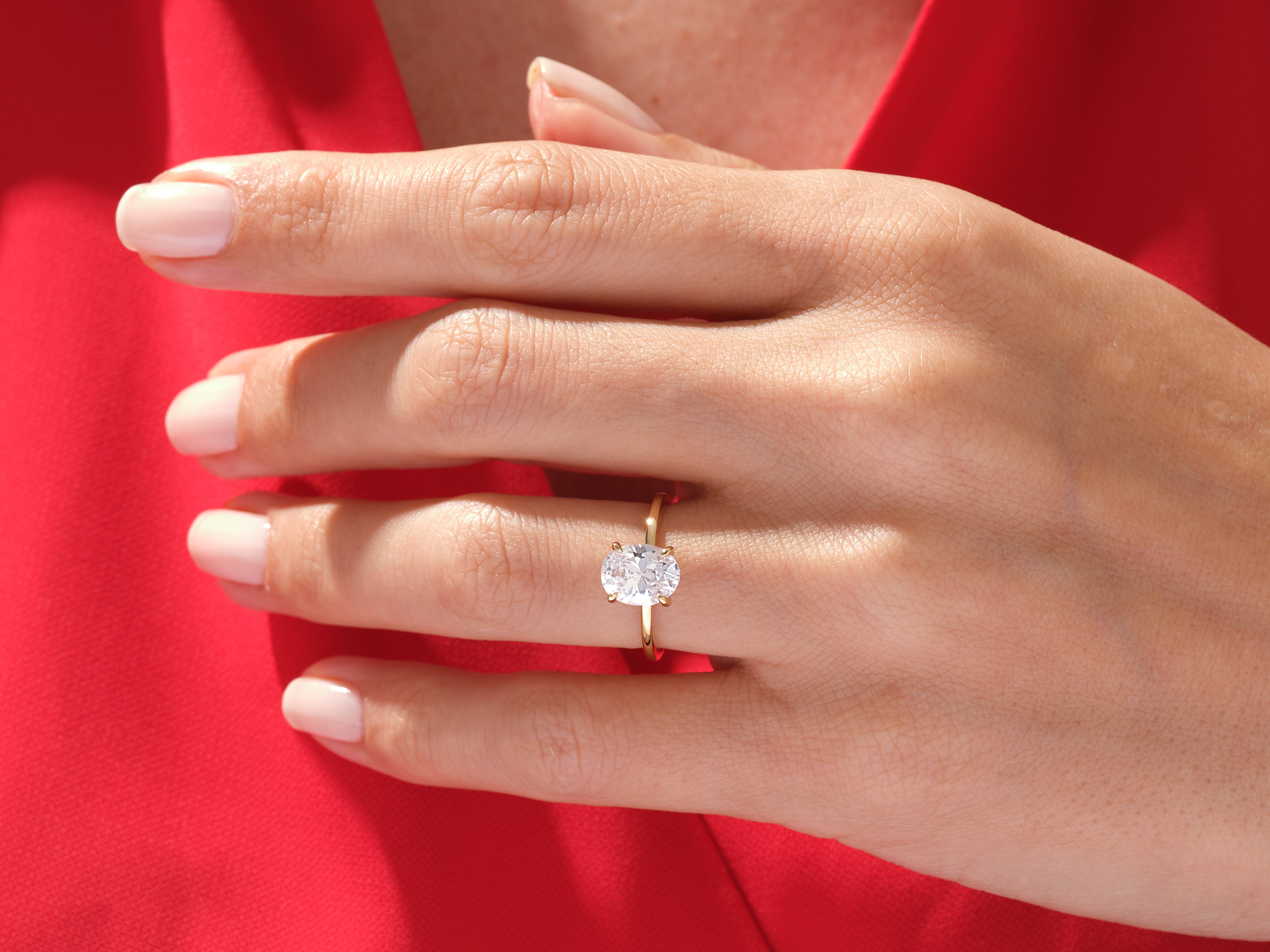 Oval diamond engagement ring on a hand, jewelry