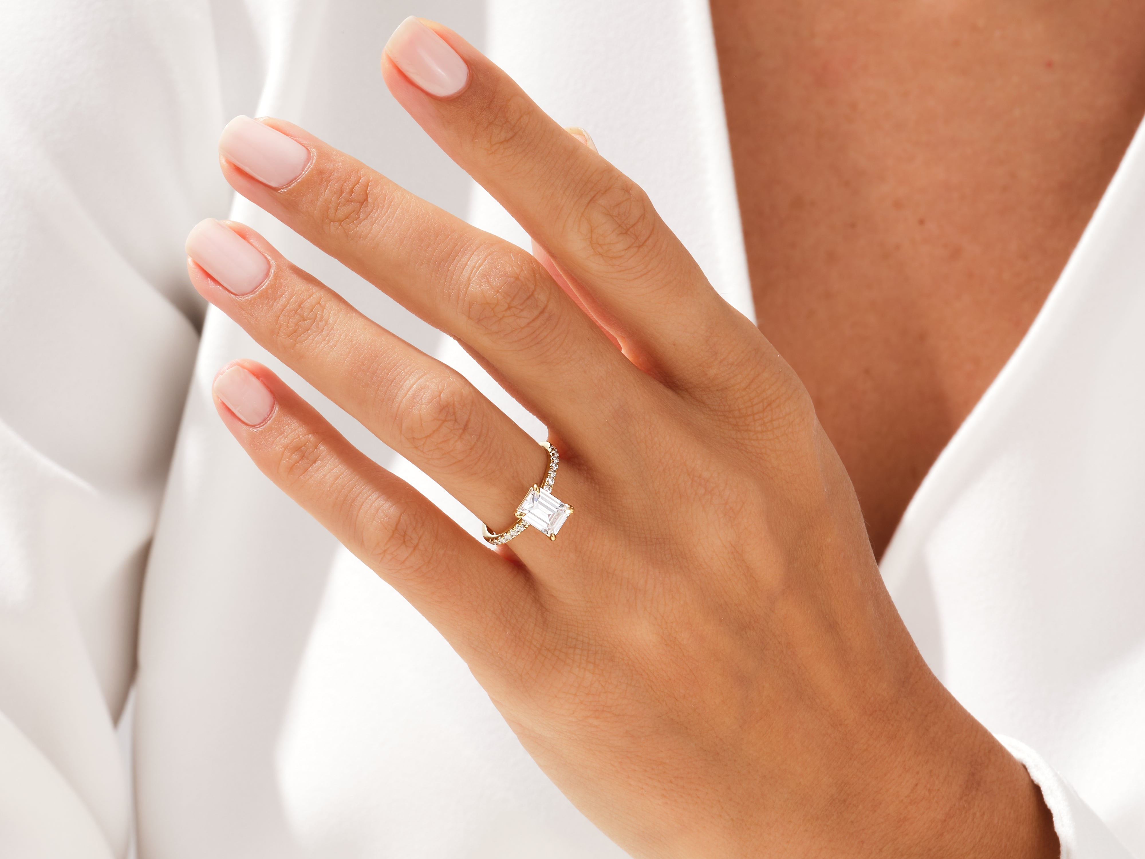 Emerald cut diamond ring on a hand, fine jewelry