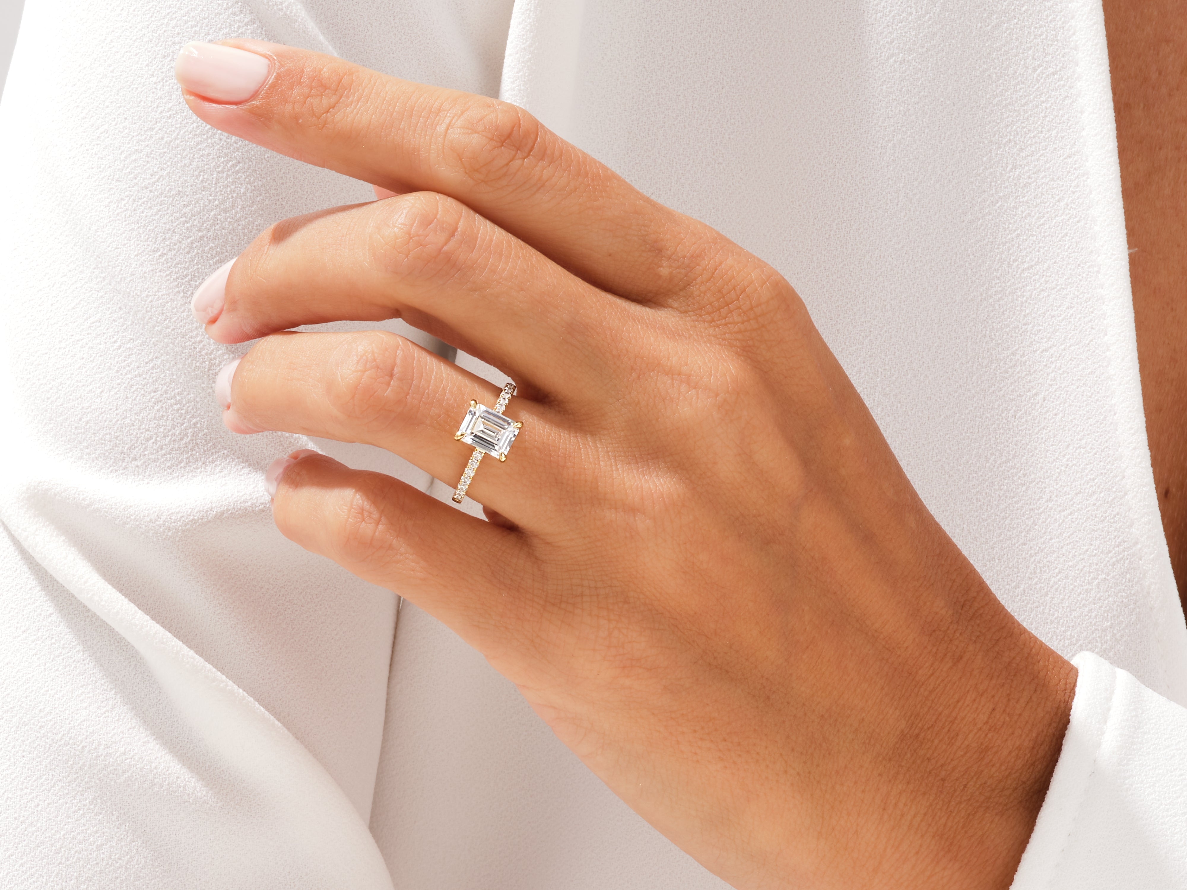 Emerald cut diamond ring on a hand, fine jewelry