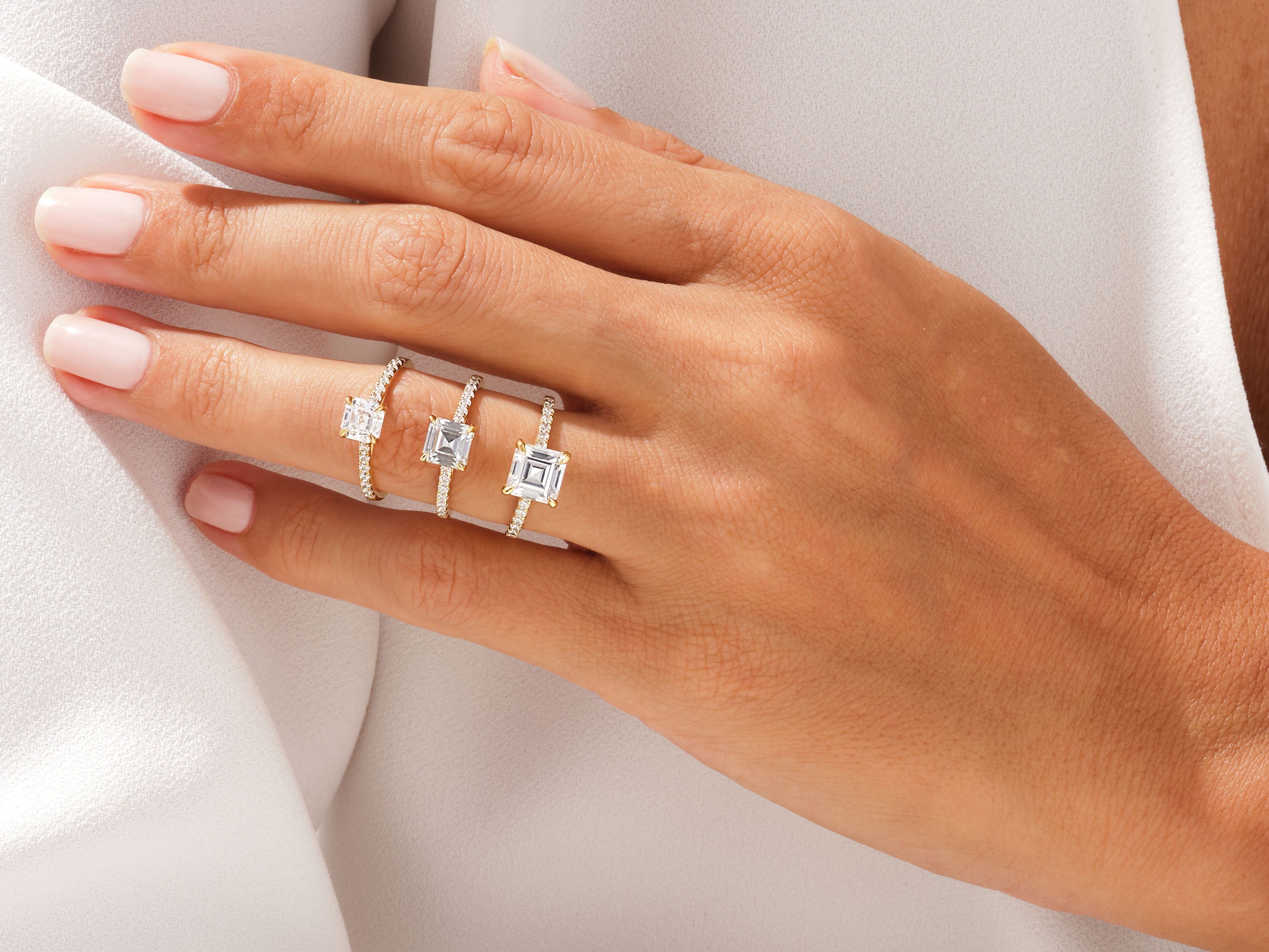 Diamond engagement rings on a hand, jewelry collection