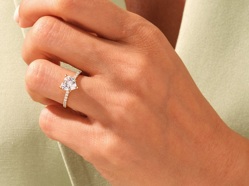 Heart-shaped diamond ring on a woman's finger, jewelry firm product