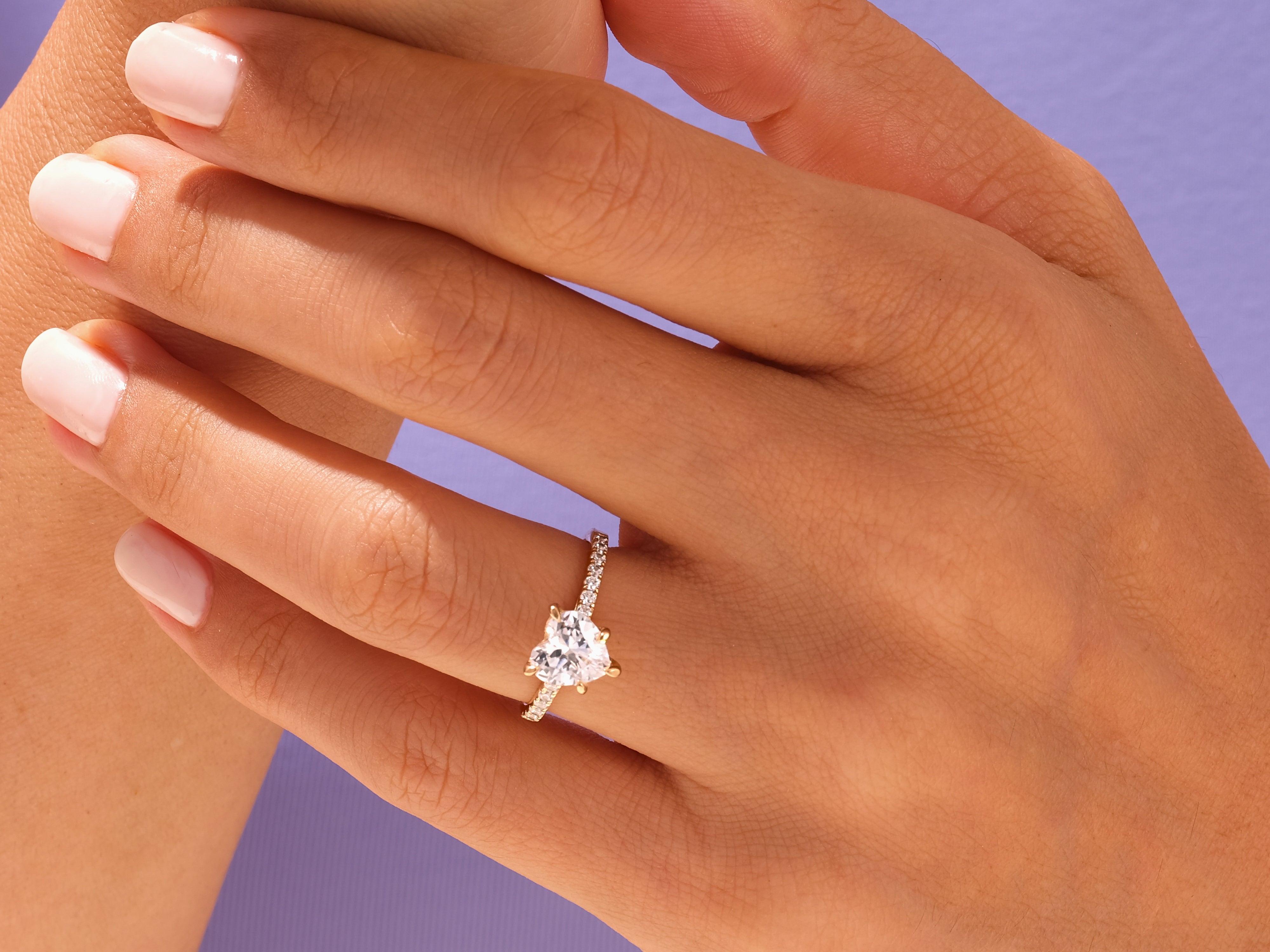 Heart-shaped diamond ring on a hand, jewelry for her