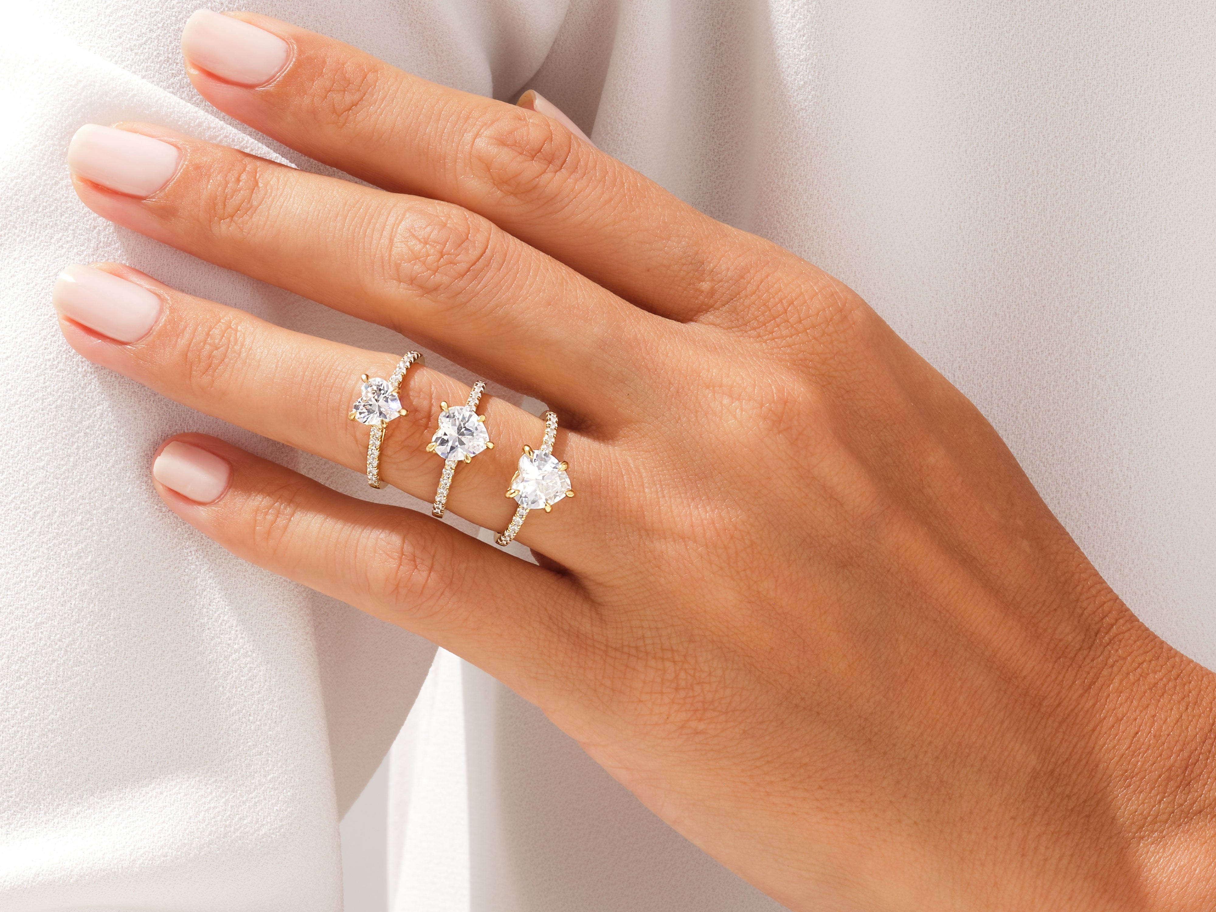 Diamond engagement rings on a hand, jewelry photography