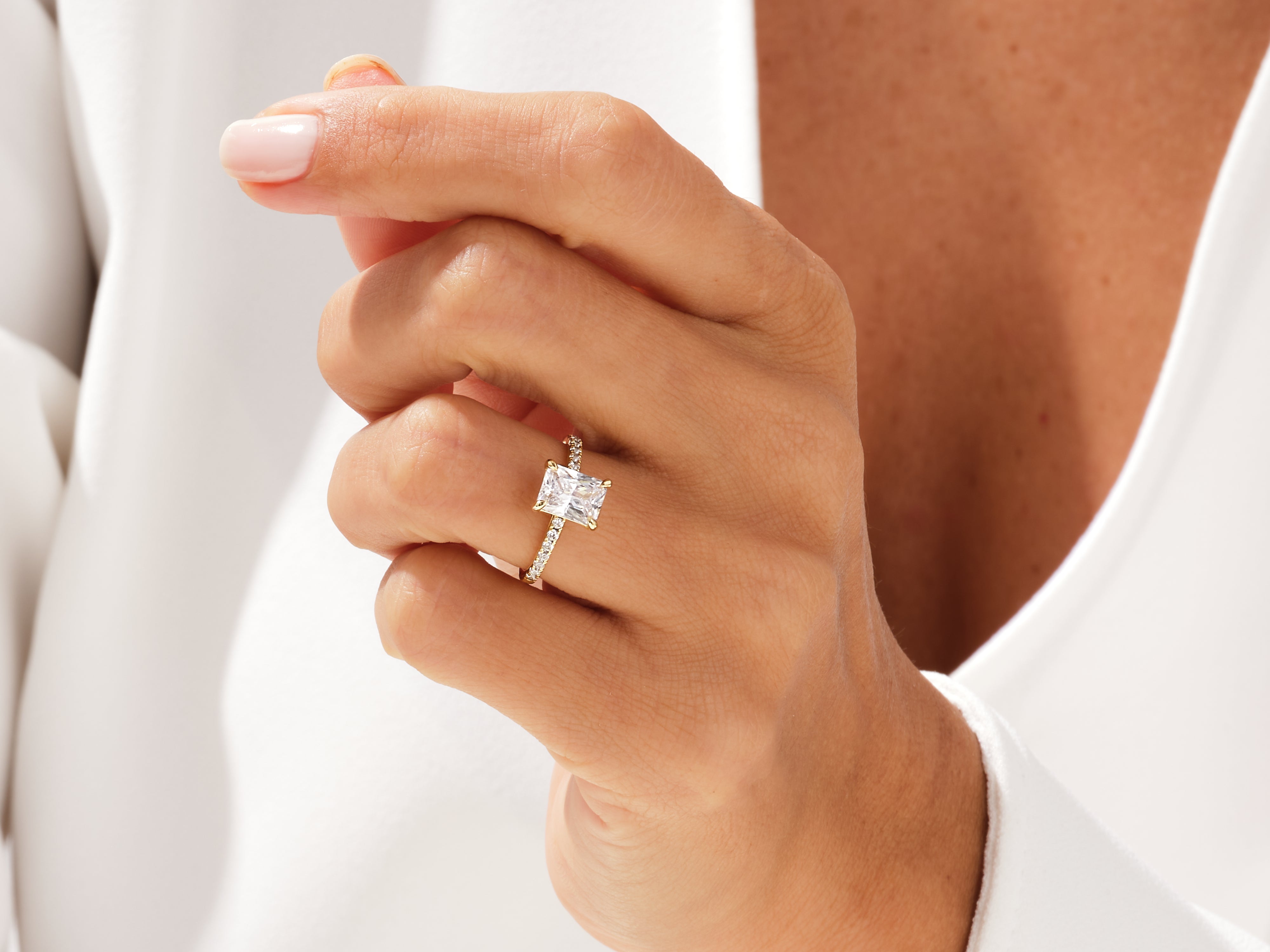 Radiant emerald cut diamond ring on a woman's hand