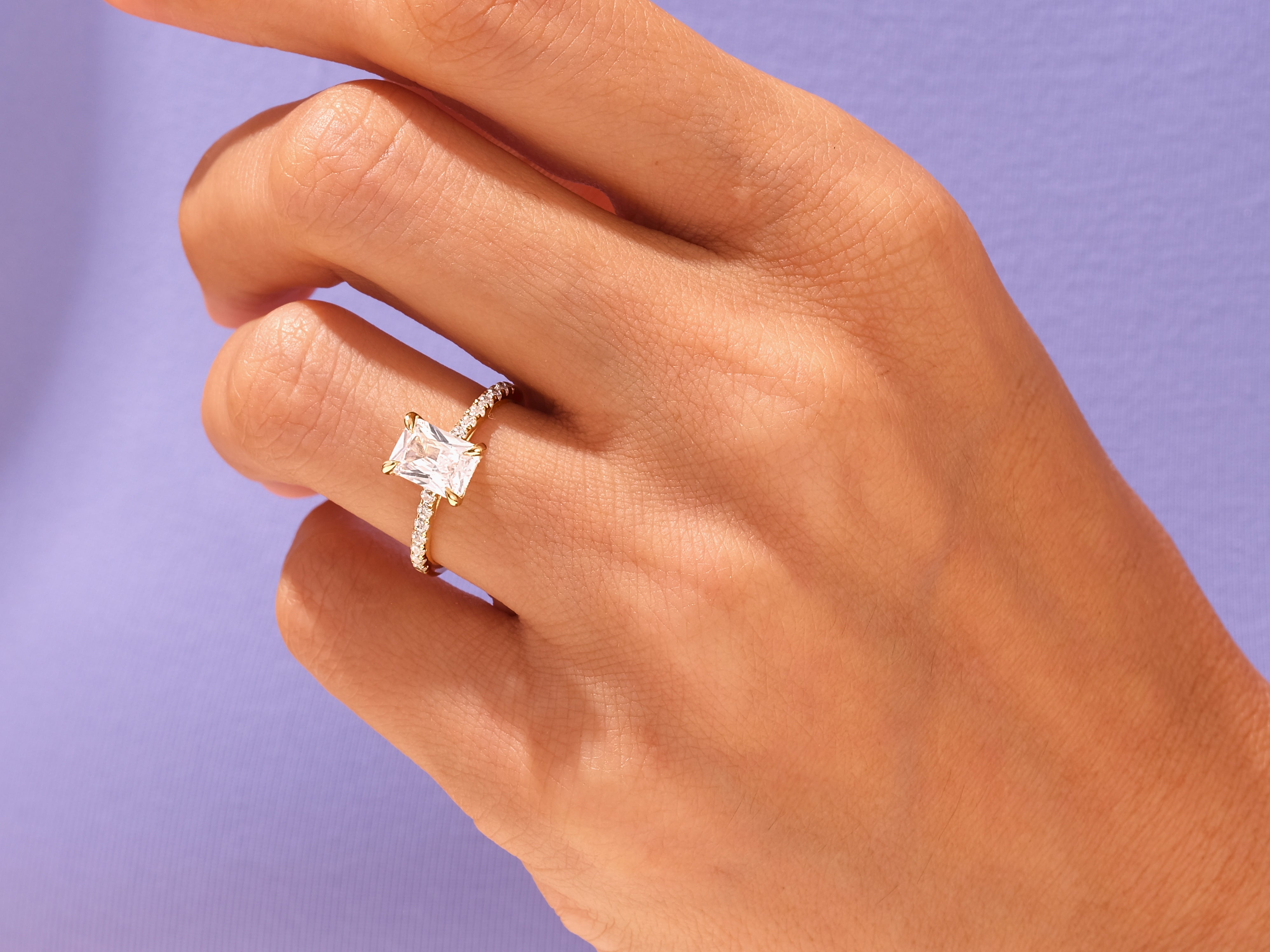 Radiant emerald cut diamond ring on a hand, jewelry