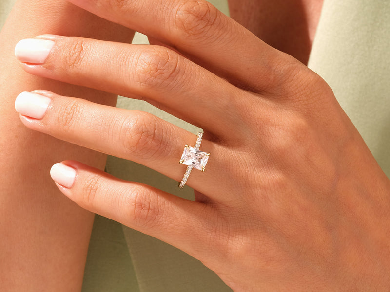 Diamond engagement ring with radiant cut stone and pave band