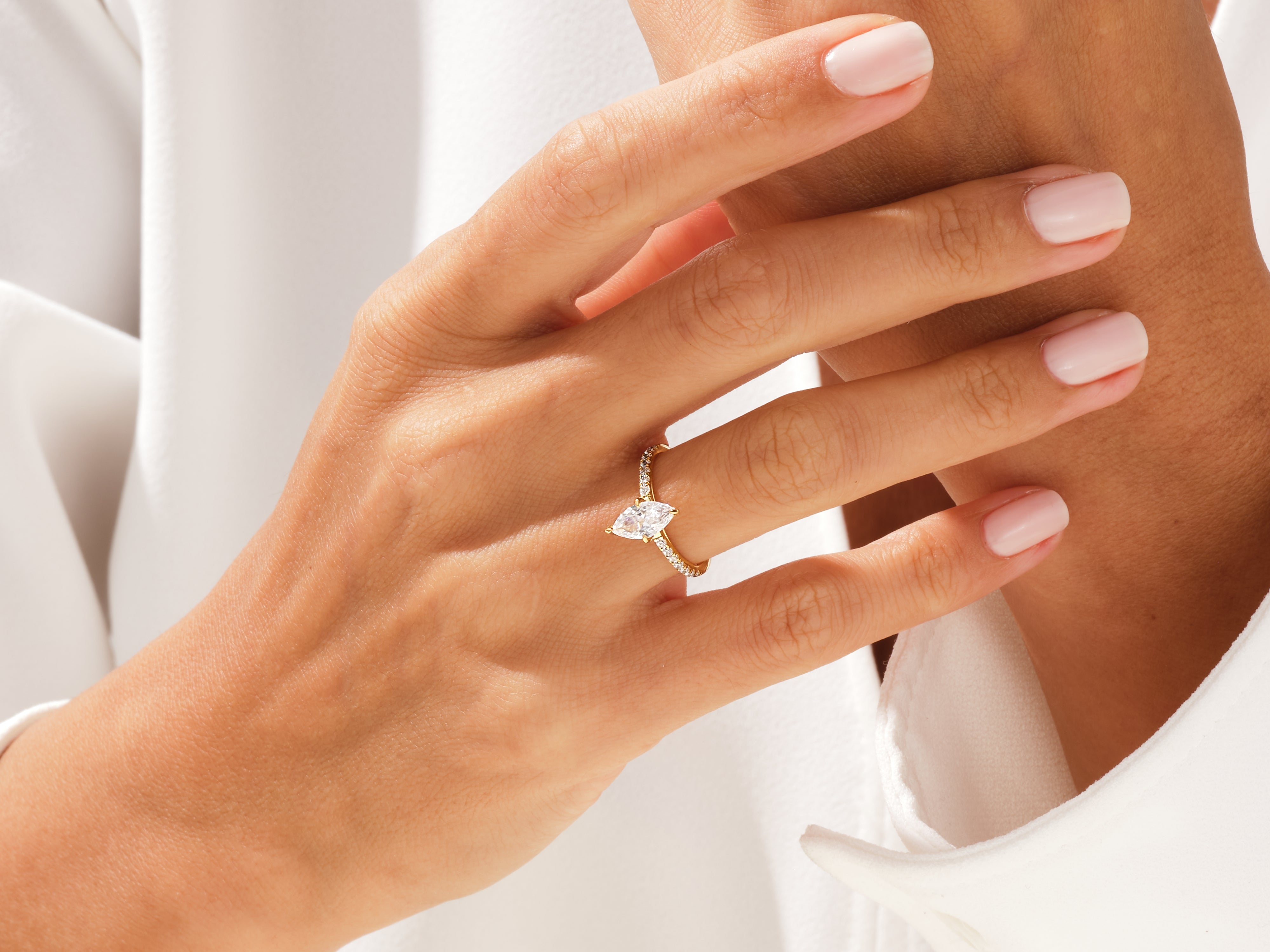 Marquise diamond engagement ring on a hand, fine jewelry