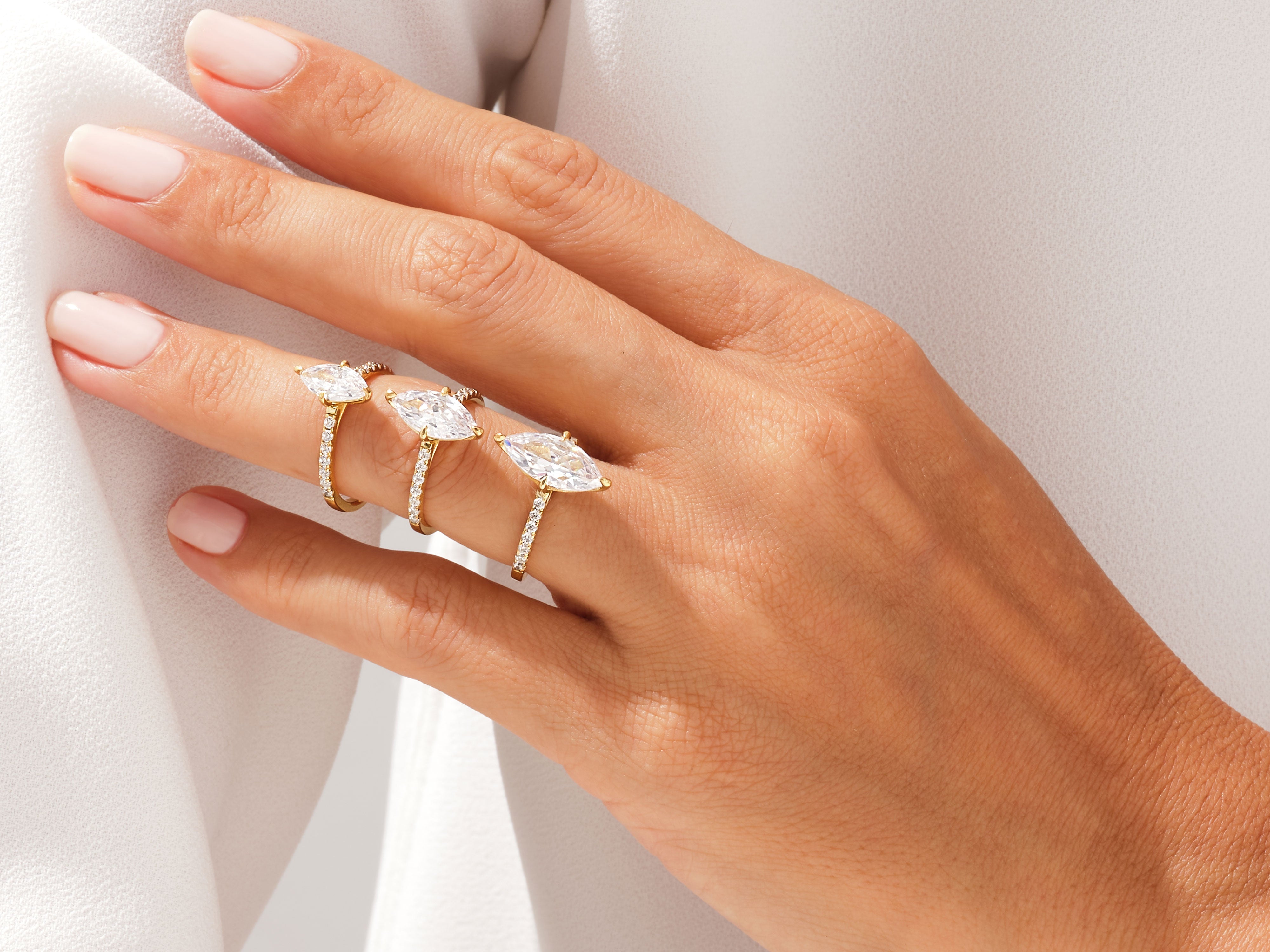Diamond marquise rings on a hand, jewelry collection