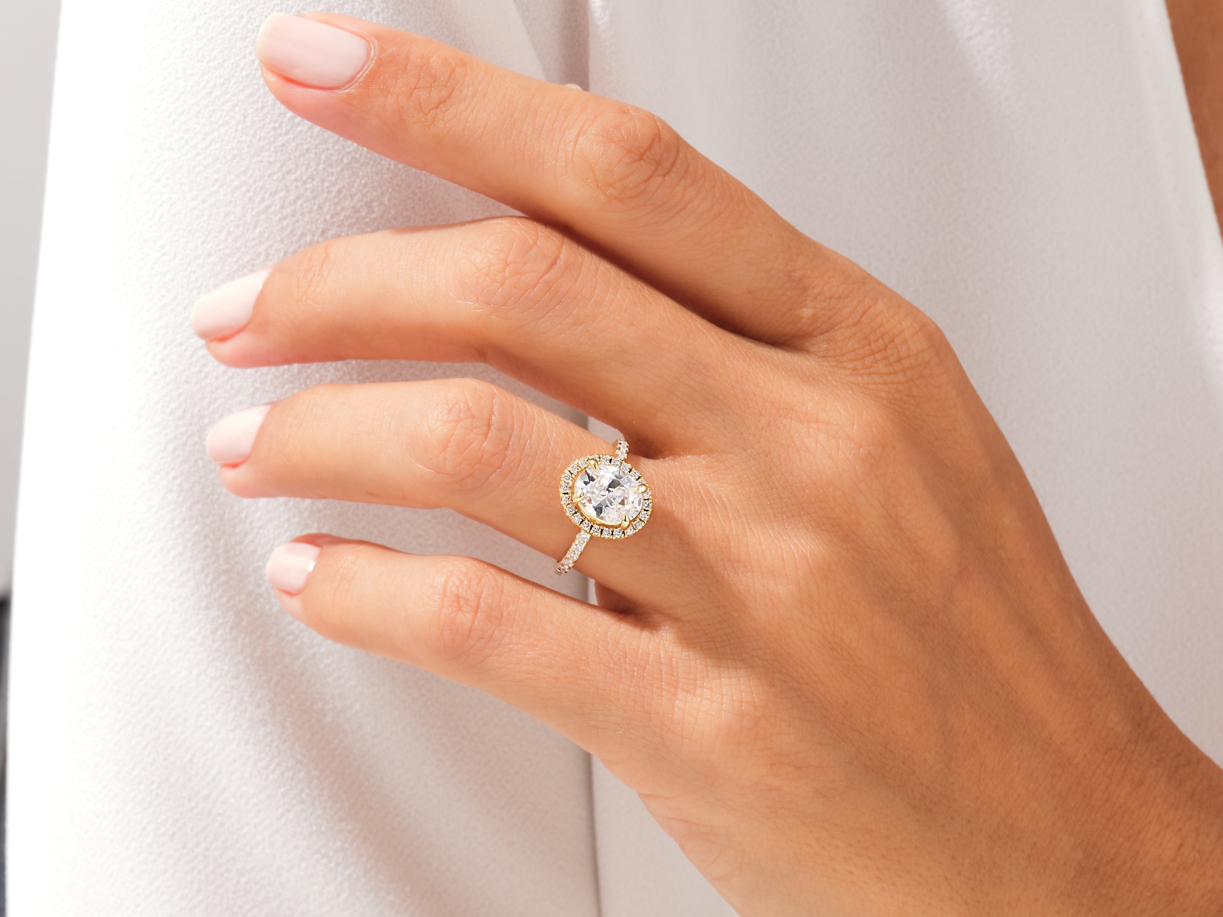 Diamond halo ring on a woman's hand, jewelry