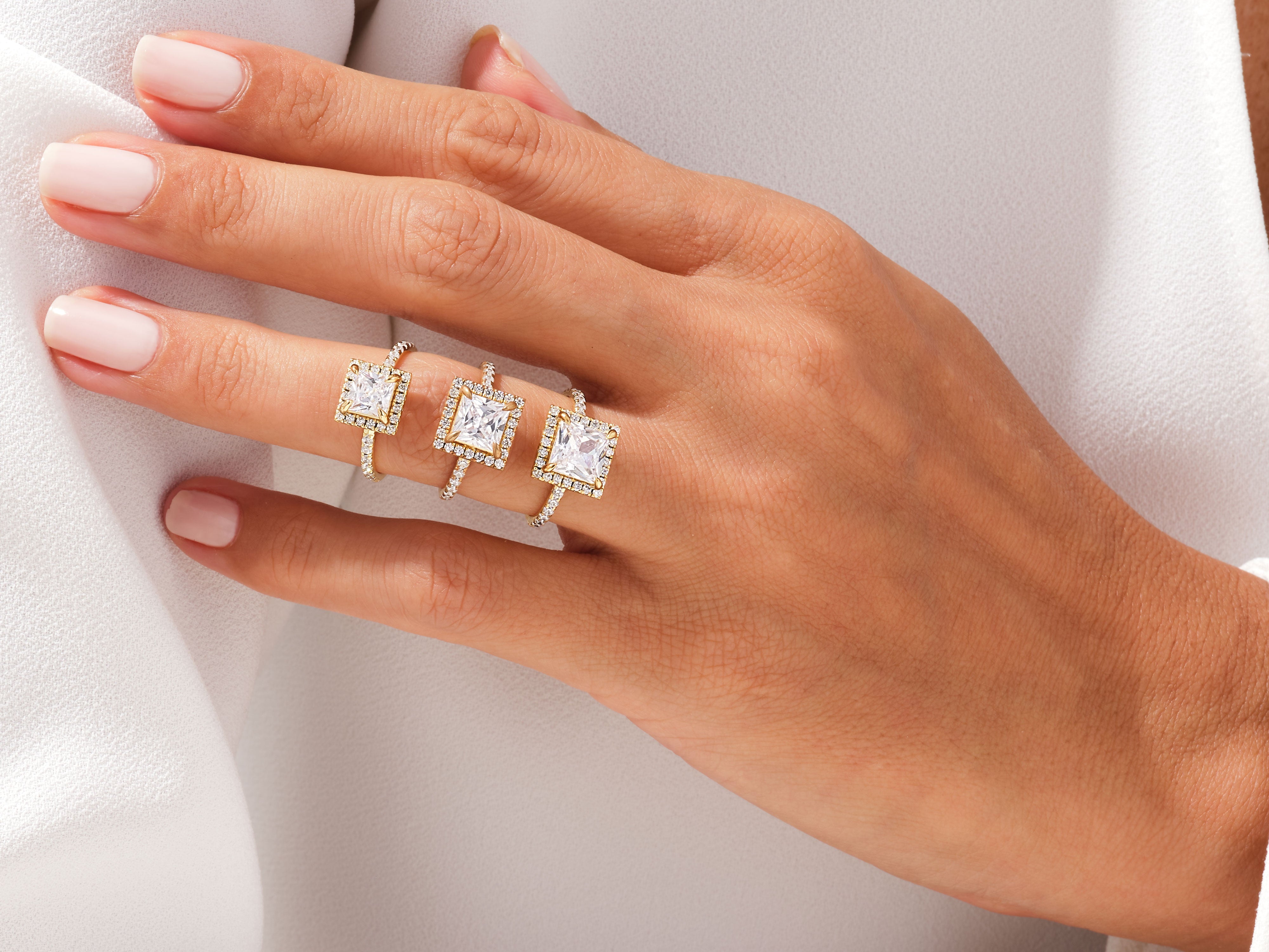 Diamond engagement rings on a hand, jewelry photography