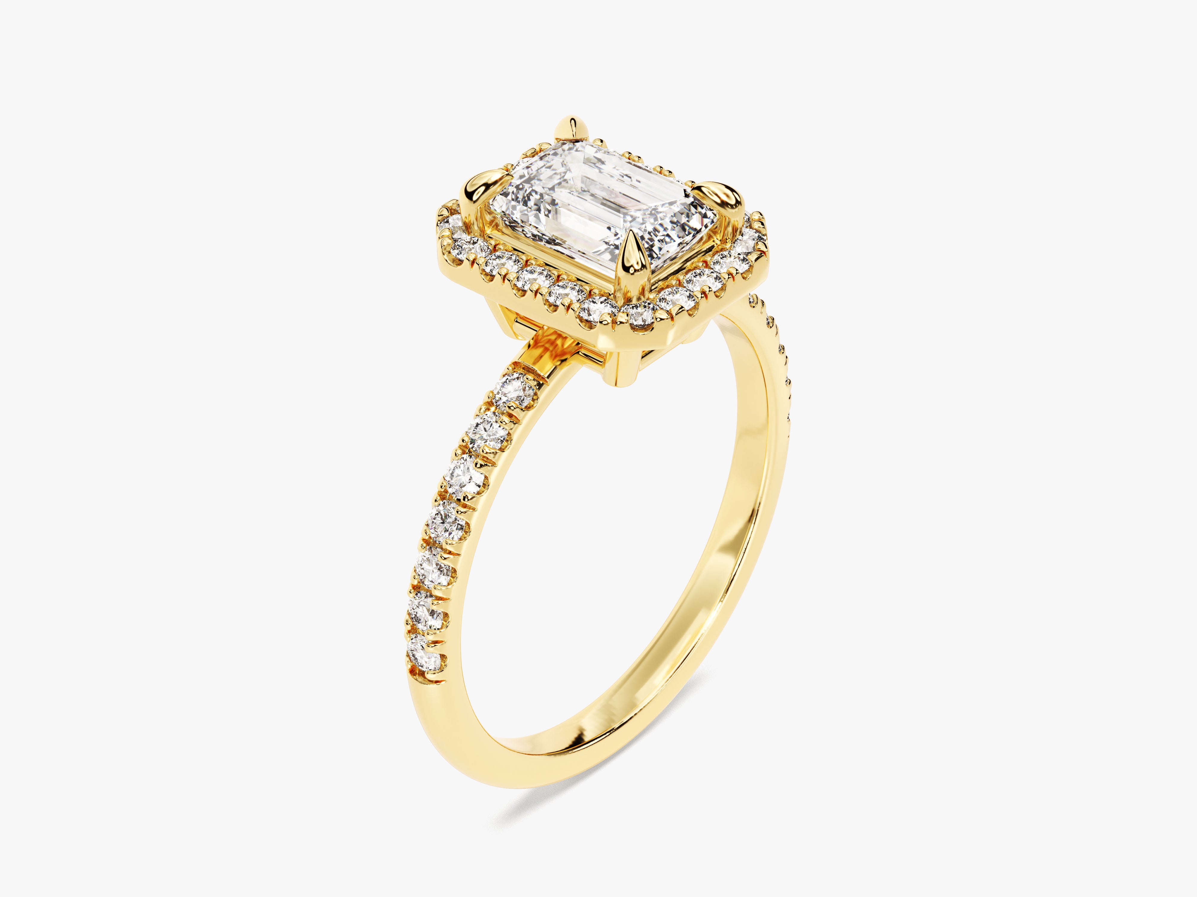 Emerald cut diamond halo engagement ring in yellow gold