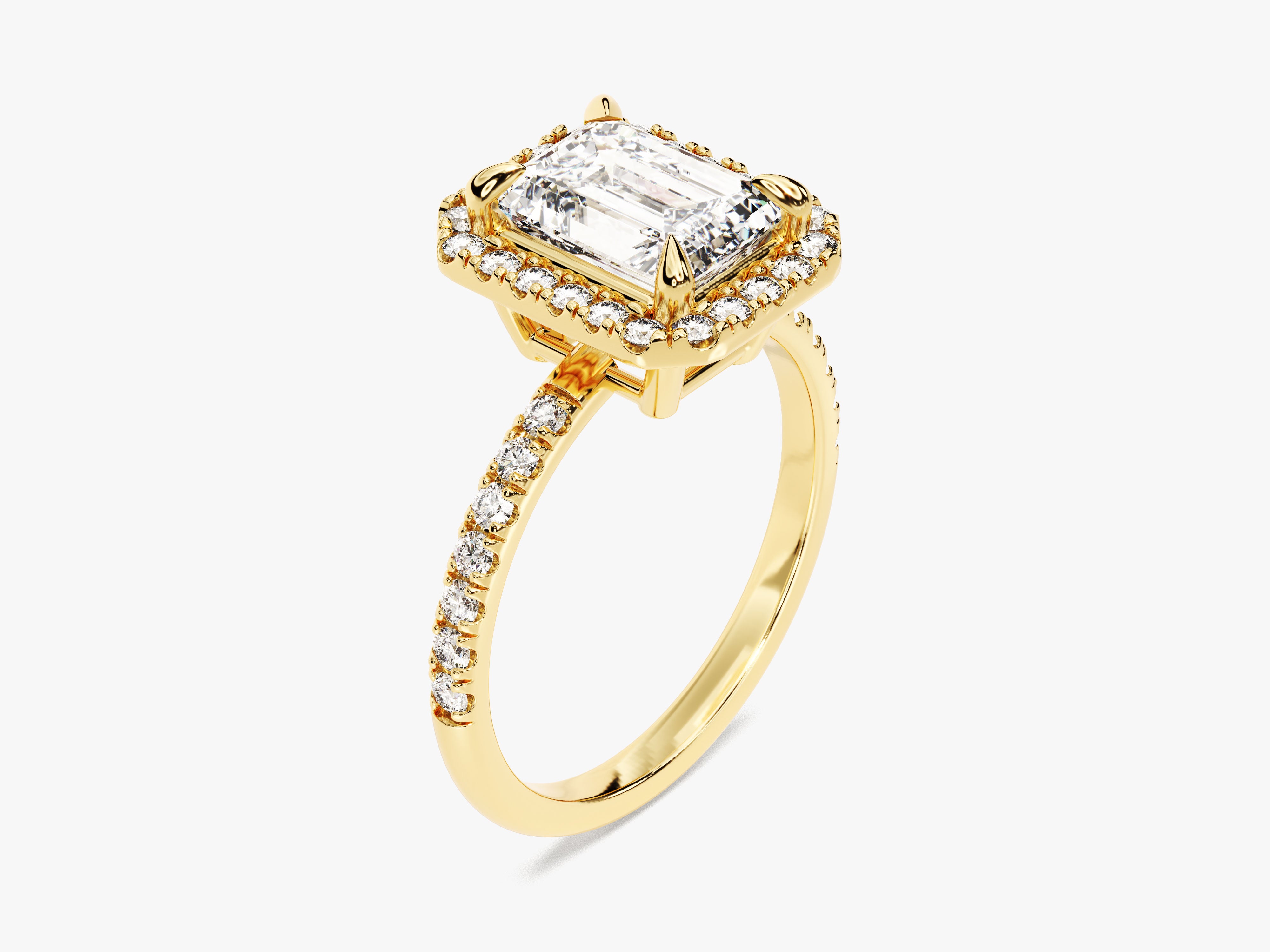 Emerald cut diamond halo engagement ring in yellow gold