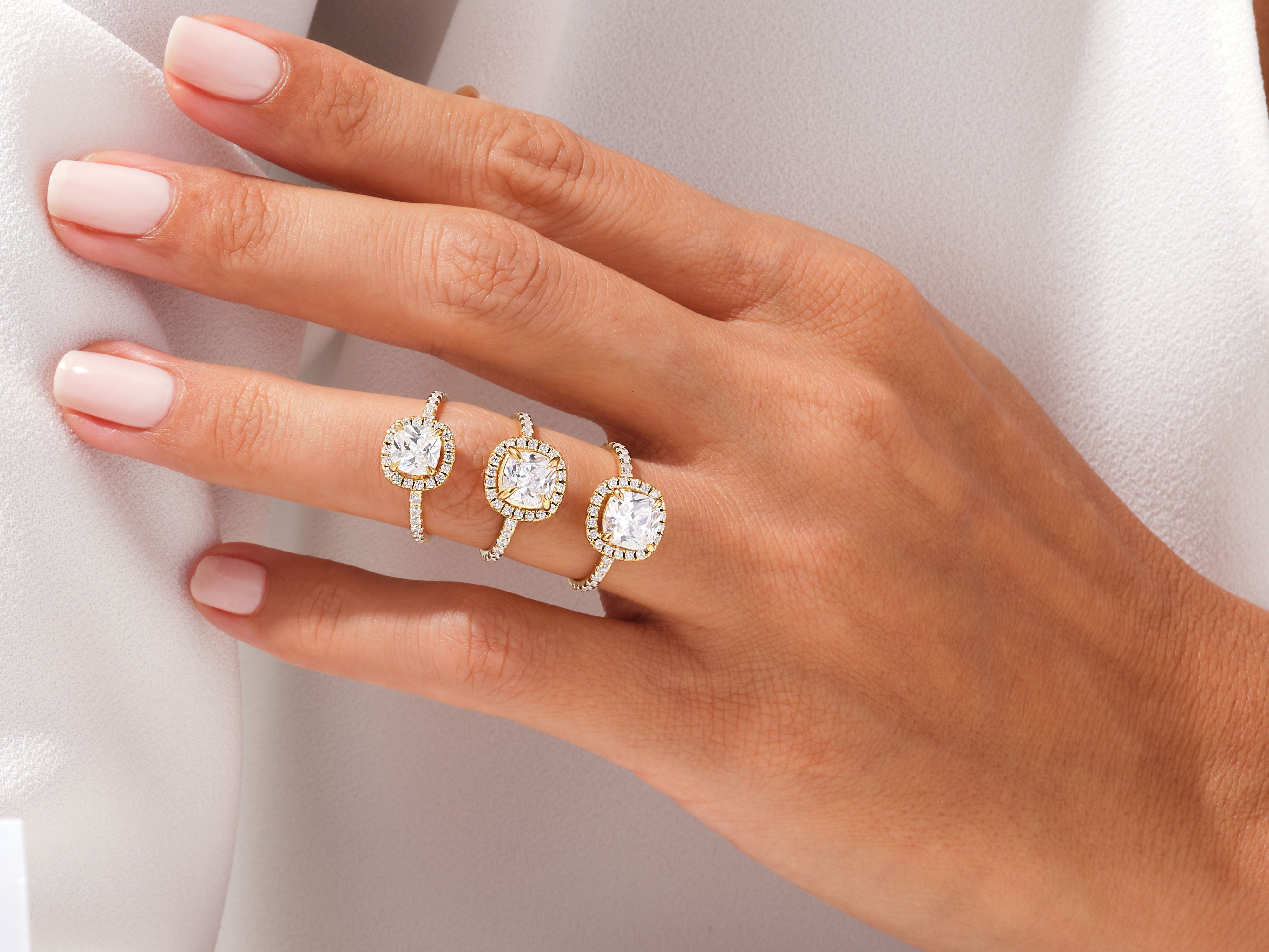 Diamond halo rings on a hand, luxury jewelry