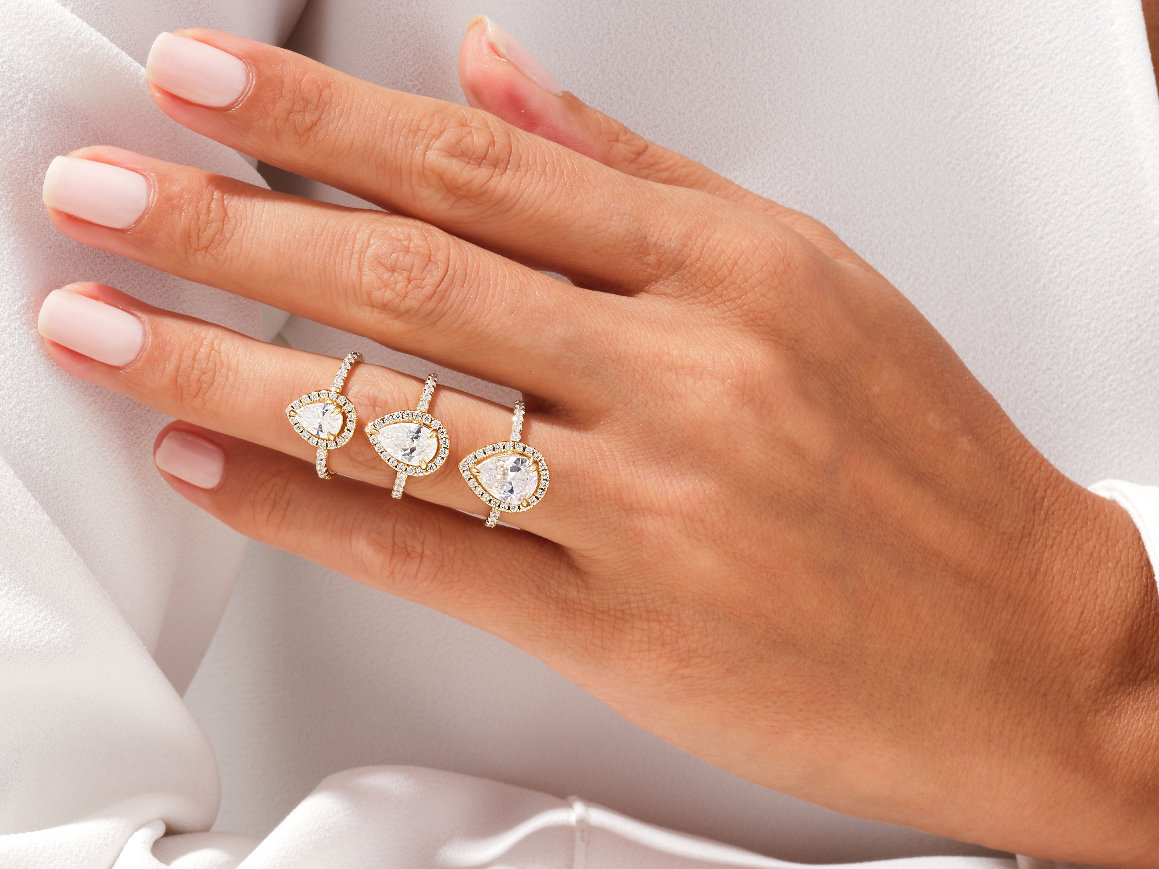 Diamond pear cut engagement rings on a hand