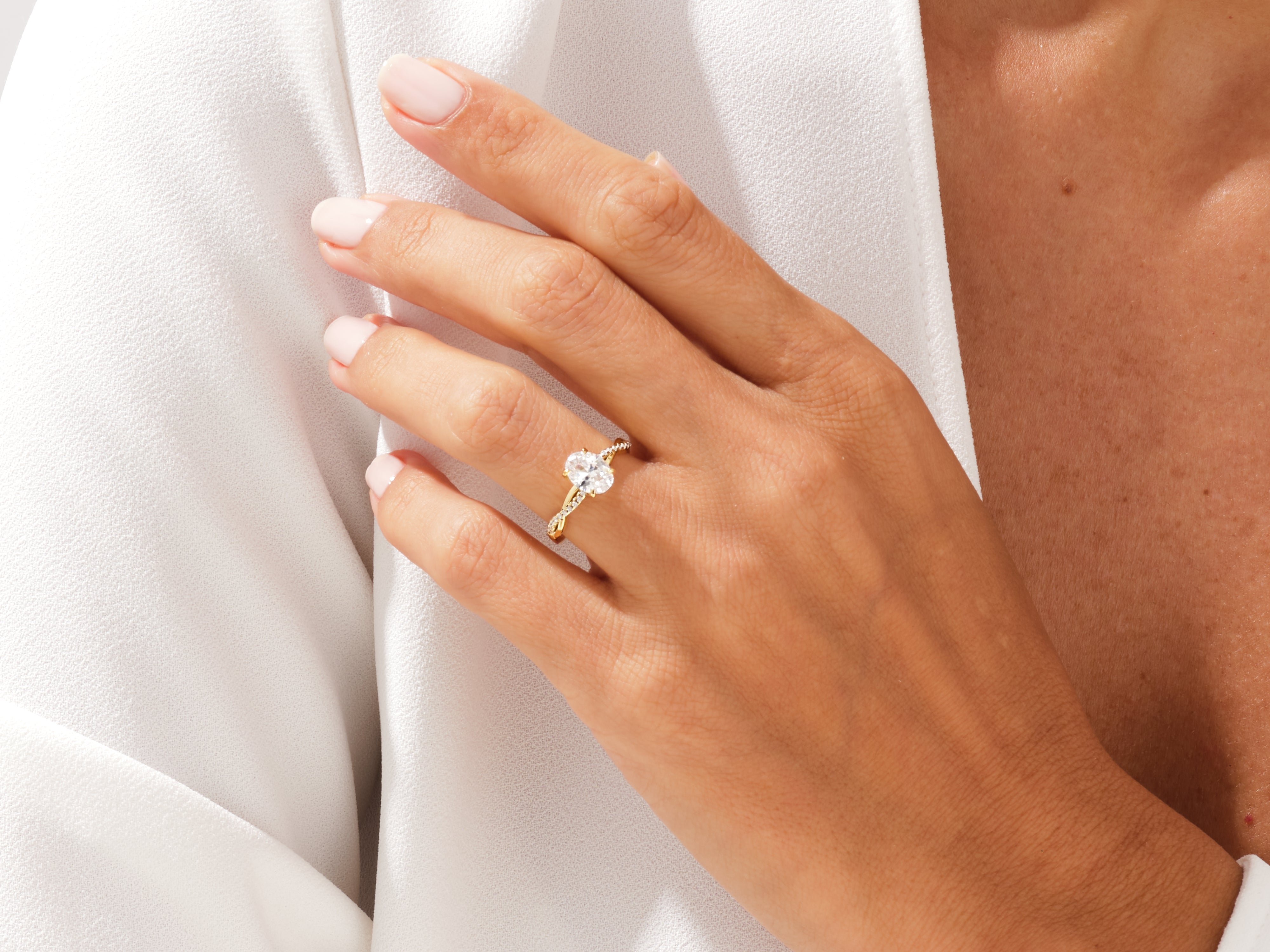 Oval diamond engagement ring on a woman's hand