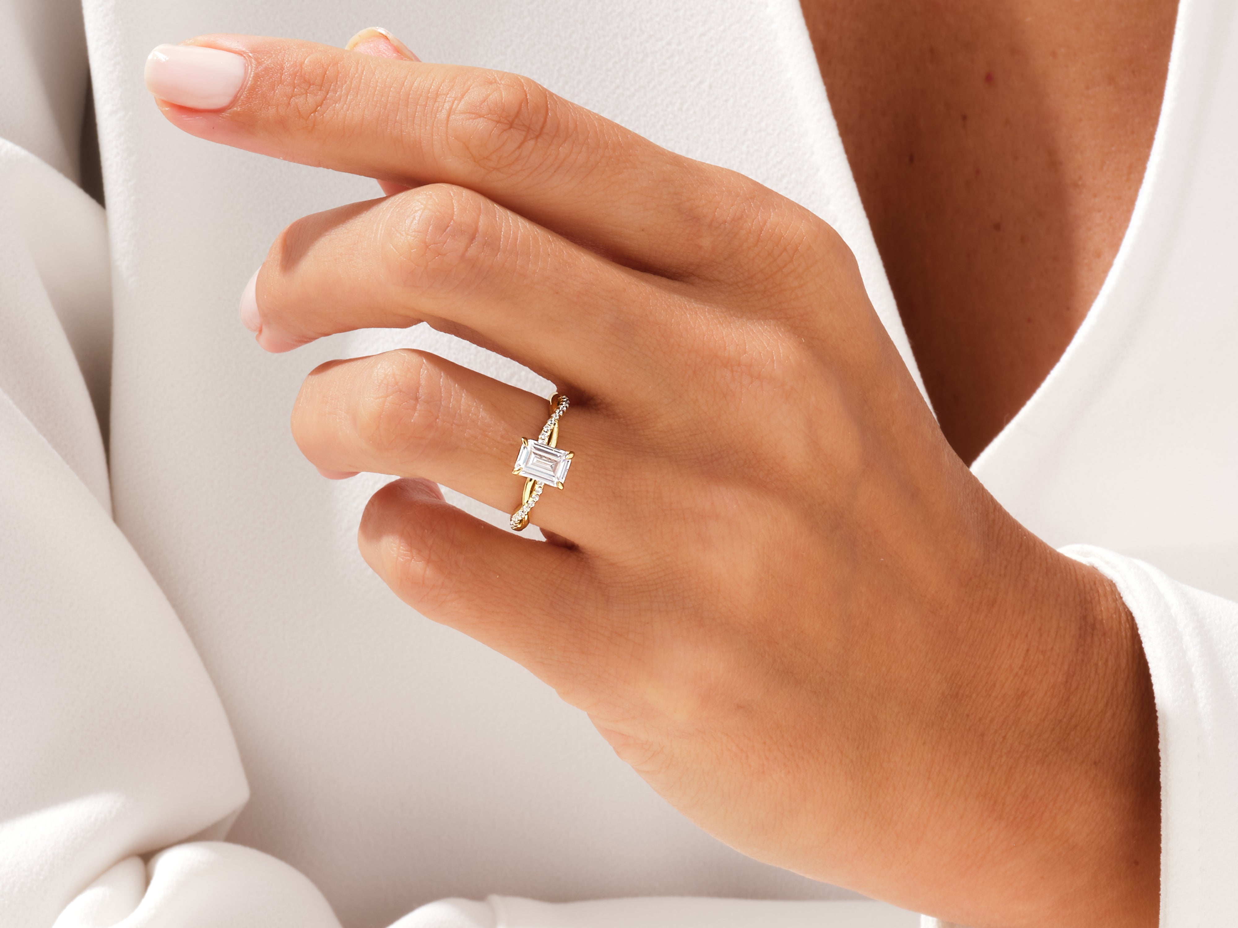 Gold baguette diamond ring on a hand