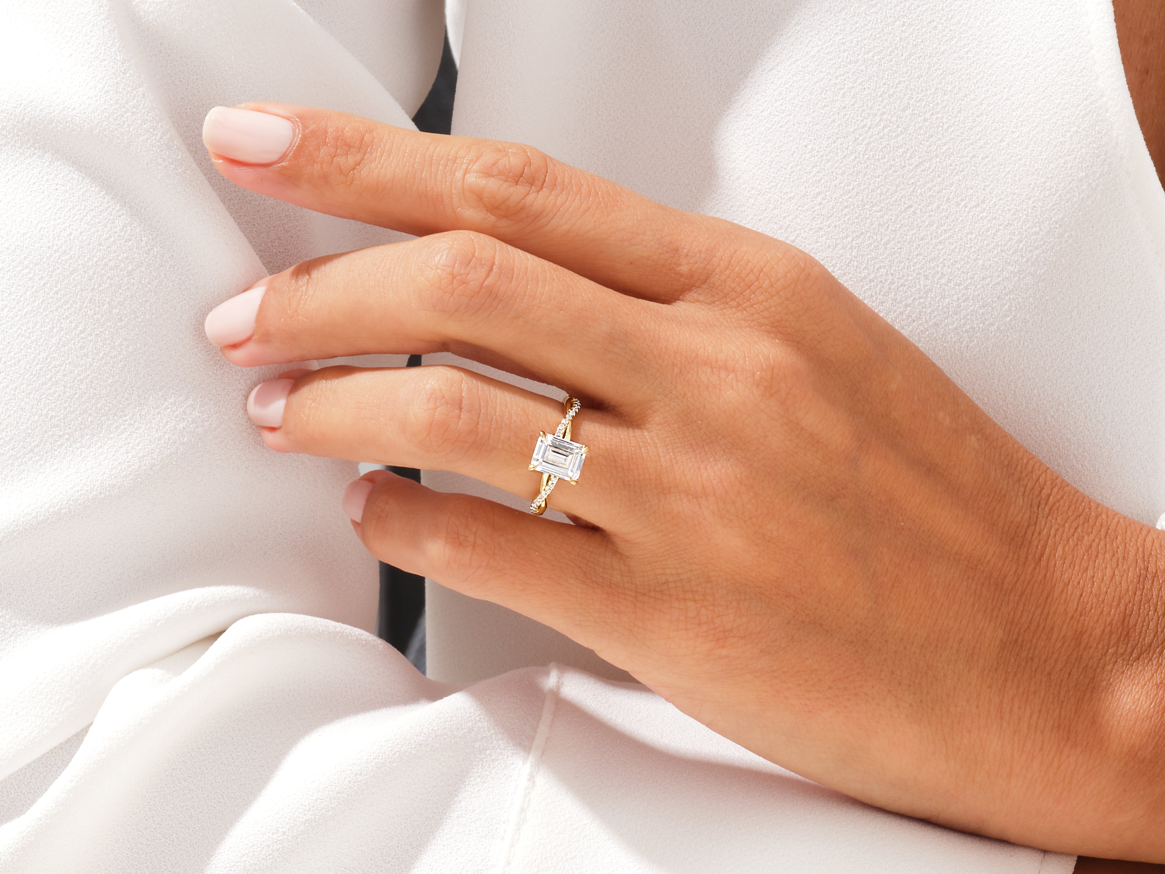 Emerald cut diamond ring on a hand, fine jewelry