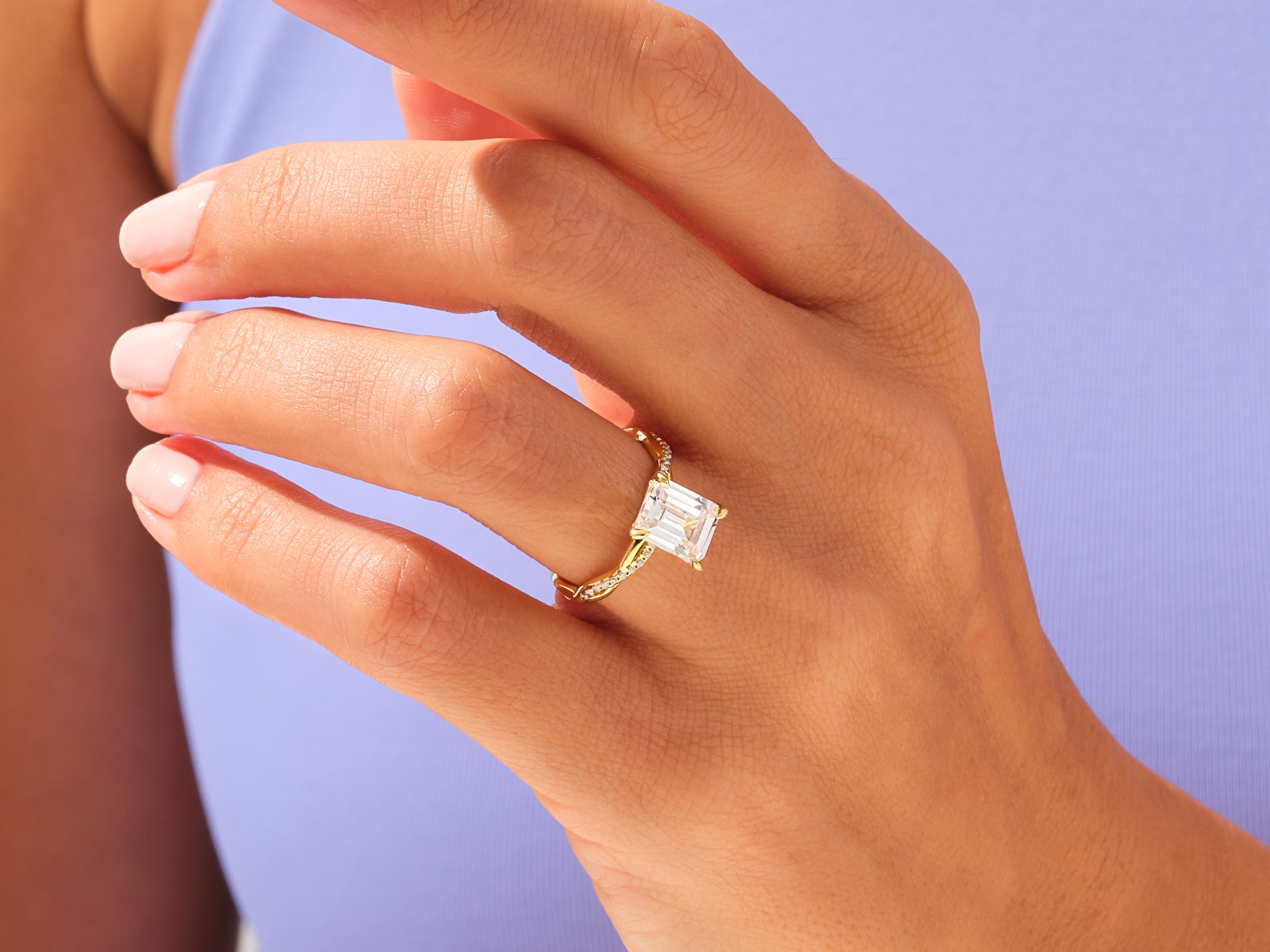 Emerald cut diamond ring on a hand, fine jewelry for her