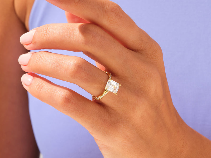 Emerald cut diamond ring on a hand, fine jewelry for her