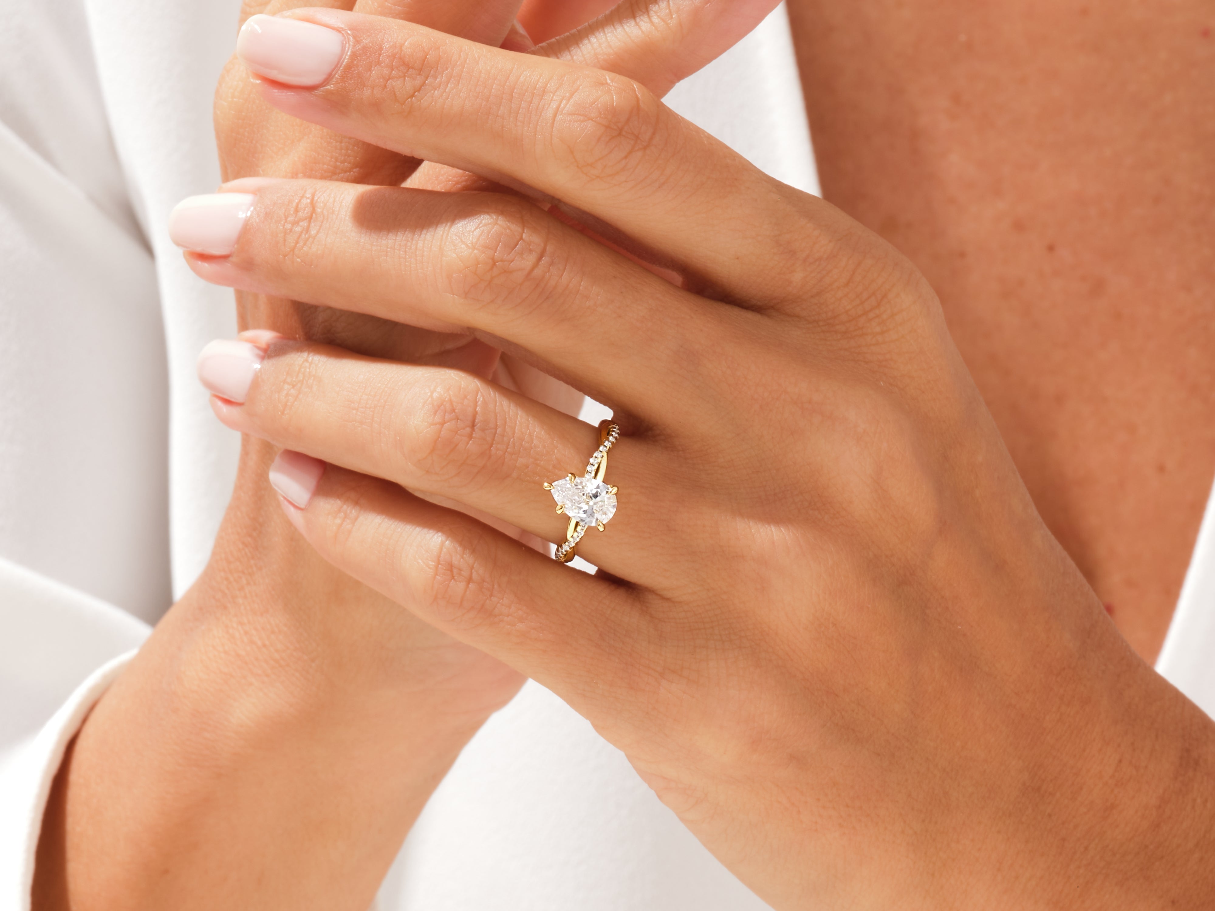 Pear-shaped diamond engagement ring on a woman's hand
