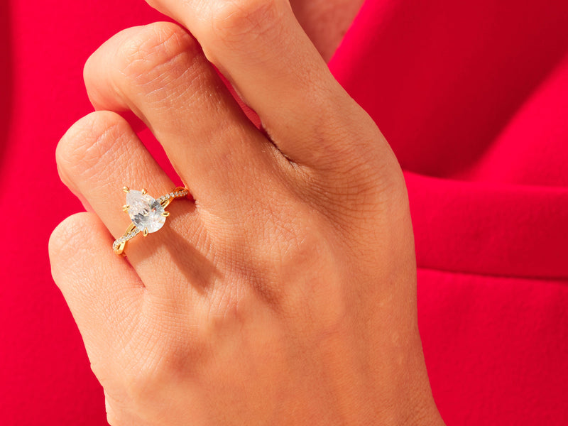 Gold pear-cut diamond ring on hand, luxury jewelry