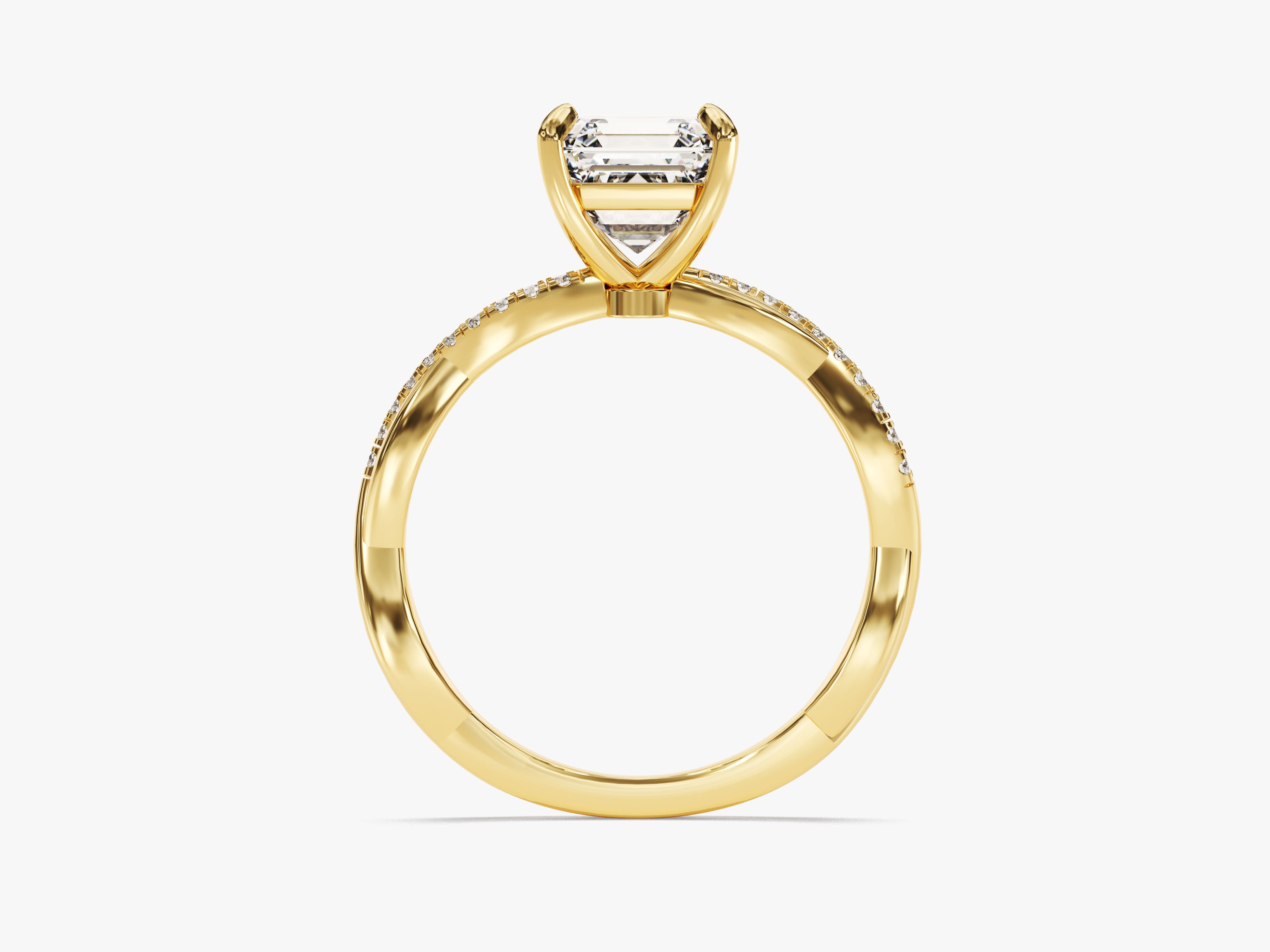Emerald cut diamond ring in yellow gold with pave band