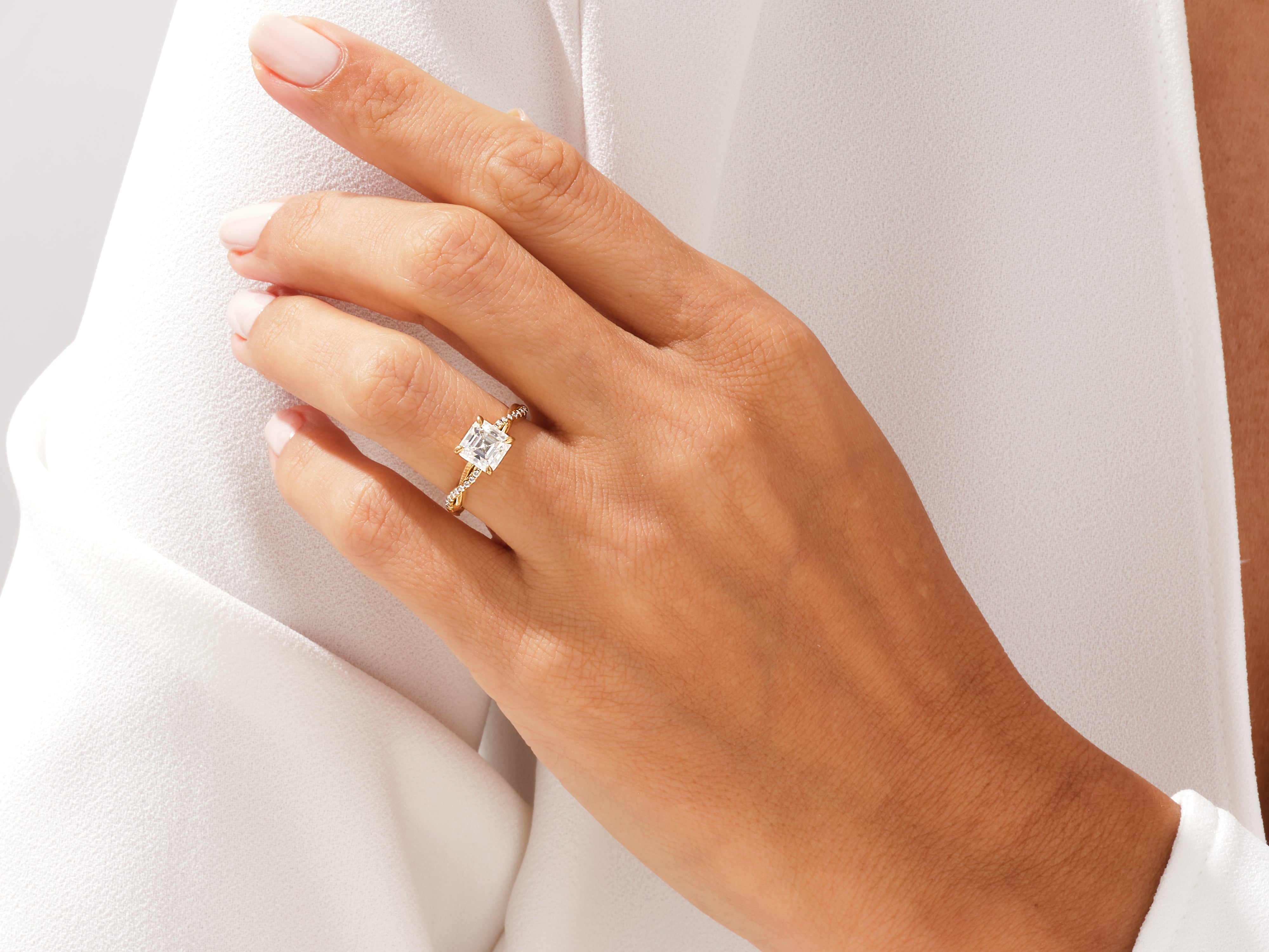 Gold engagement ring with diamond on hand