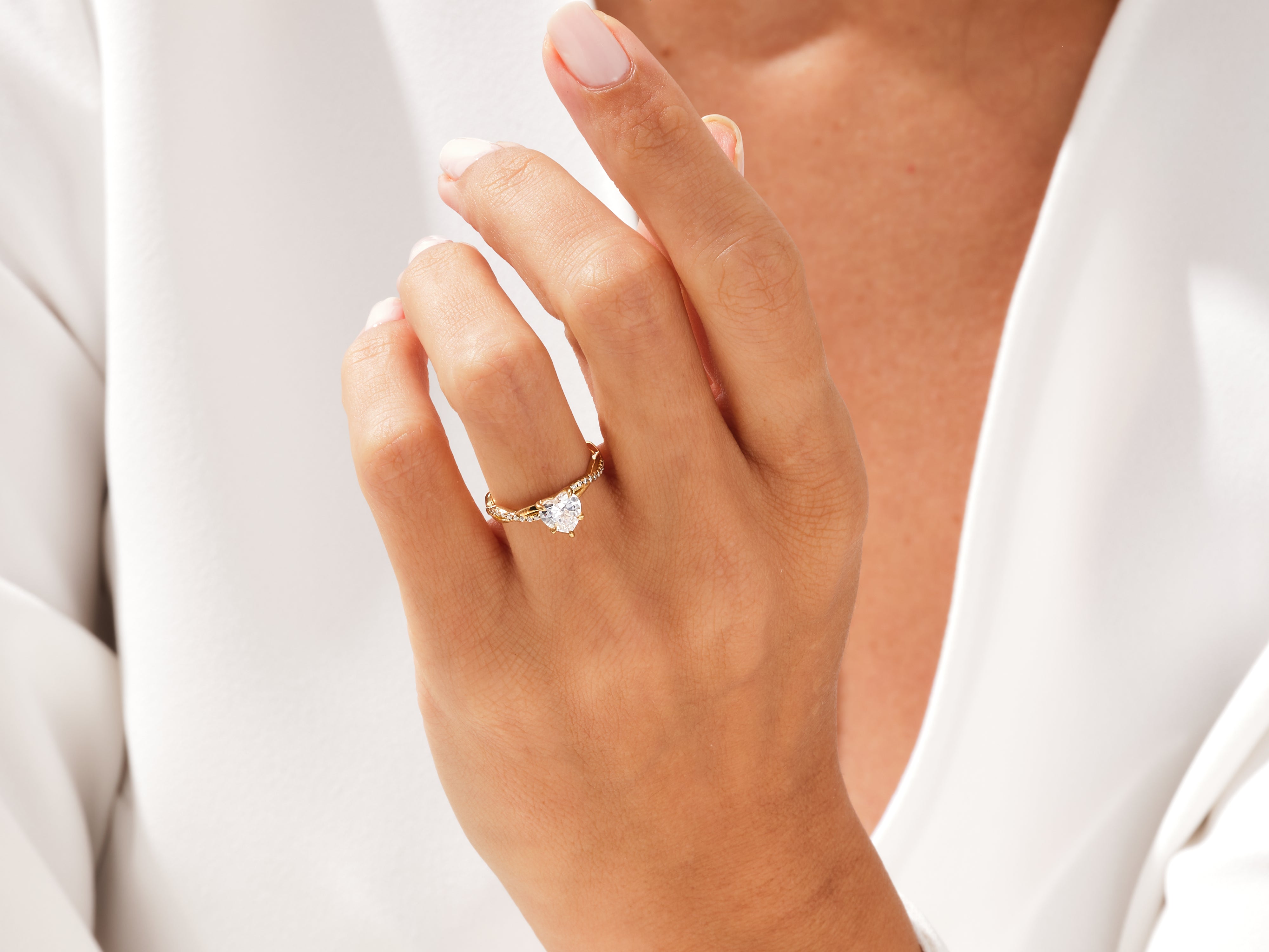 Gold heart diamond ring on a woman's hand