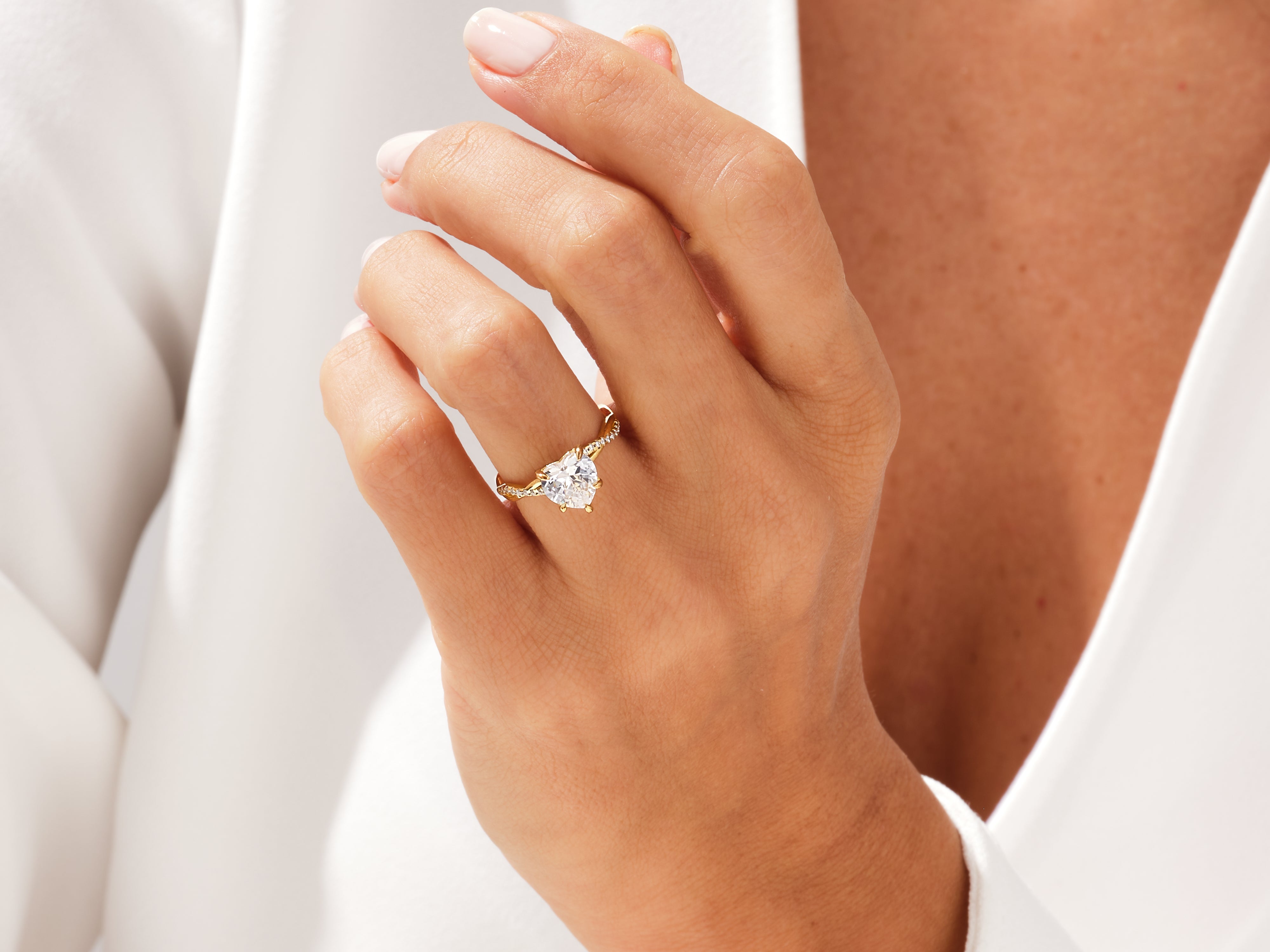 Heart-shaped diamond engagement ring on a woman's hand