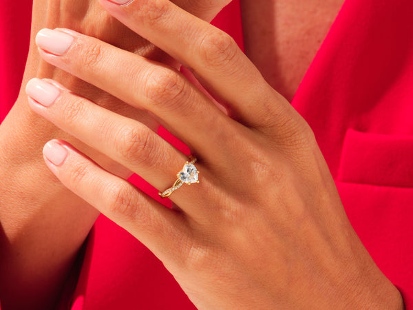 Gold heart diamond ring on hand