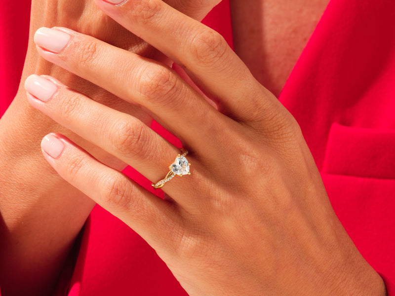 Gold heart diamond ring on hand