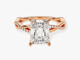 Rose gold twisted band ring with radiant cut diamond and pavé diamonds