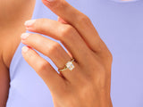 Gold ring with princess cut diamond on a woman's hand