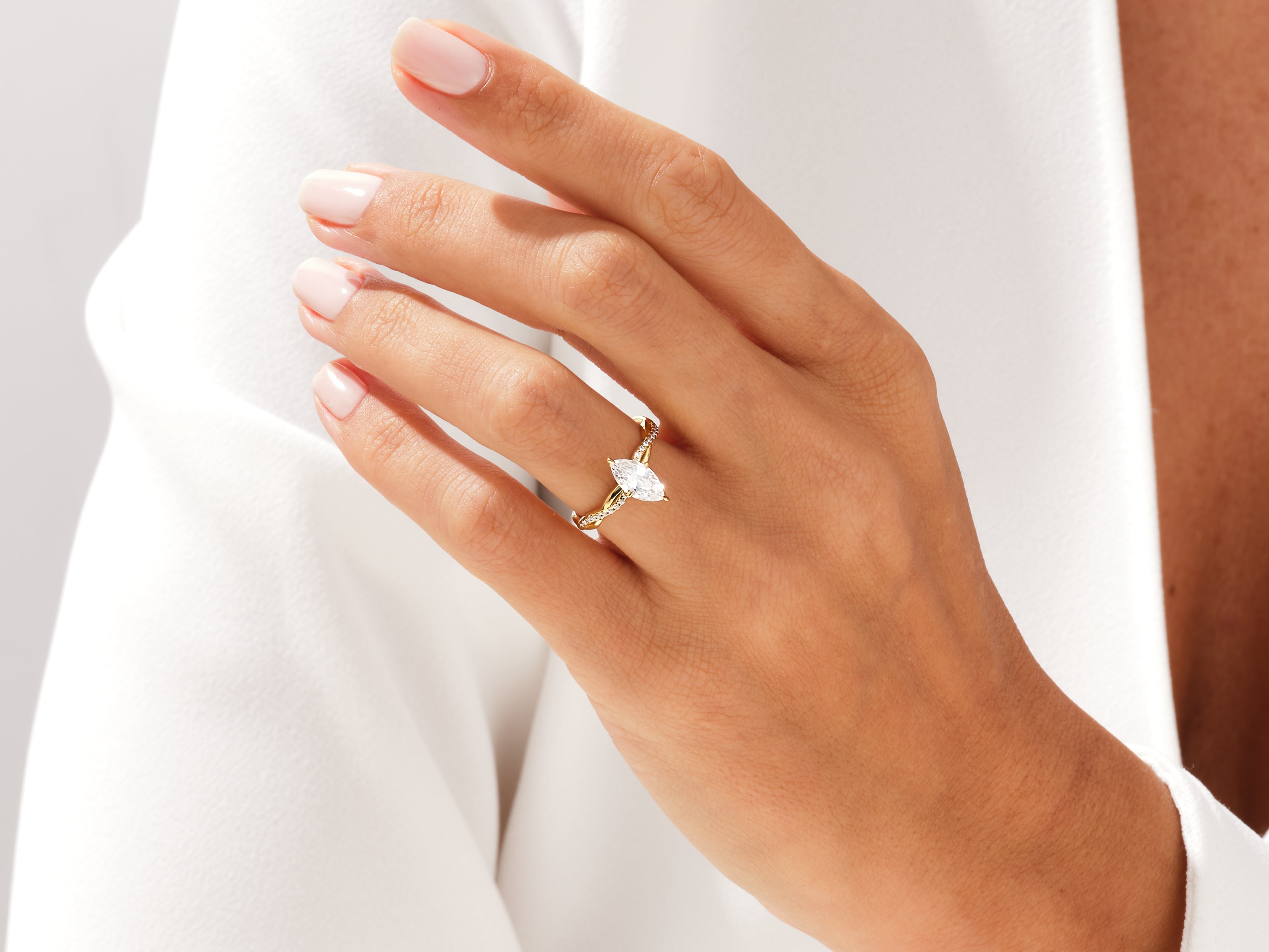 Marquise diamond engagement ring on a hand, fine jewelry