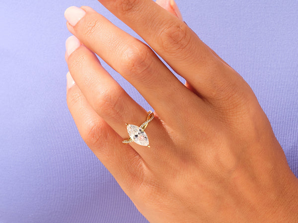 Marquise diamond ring with pave band on hand