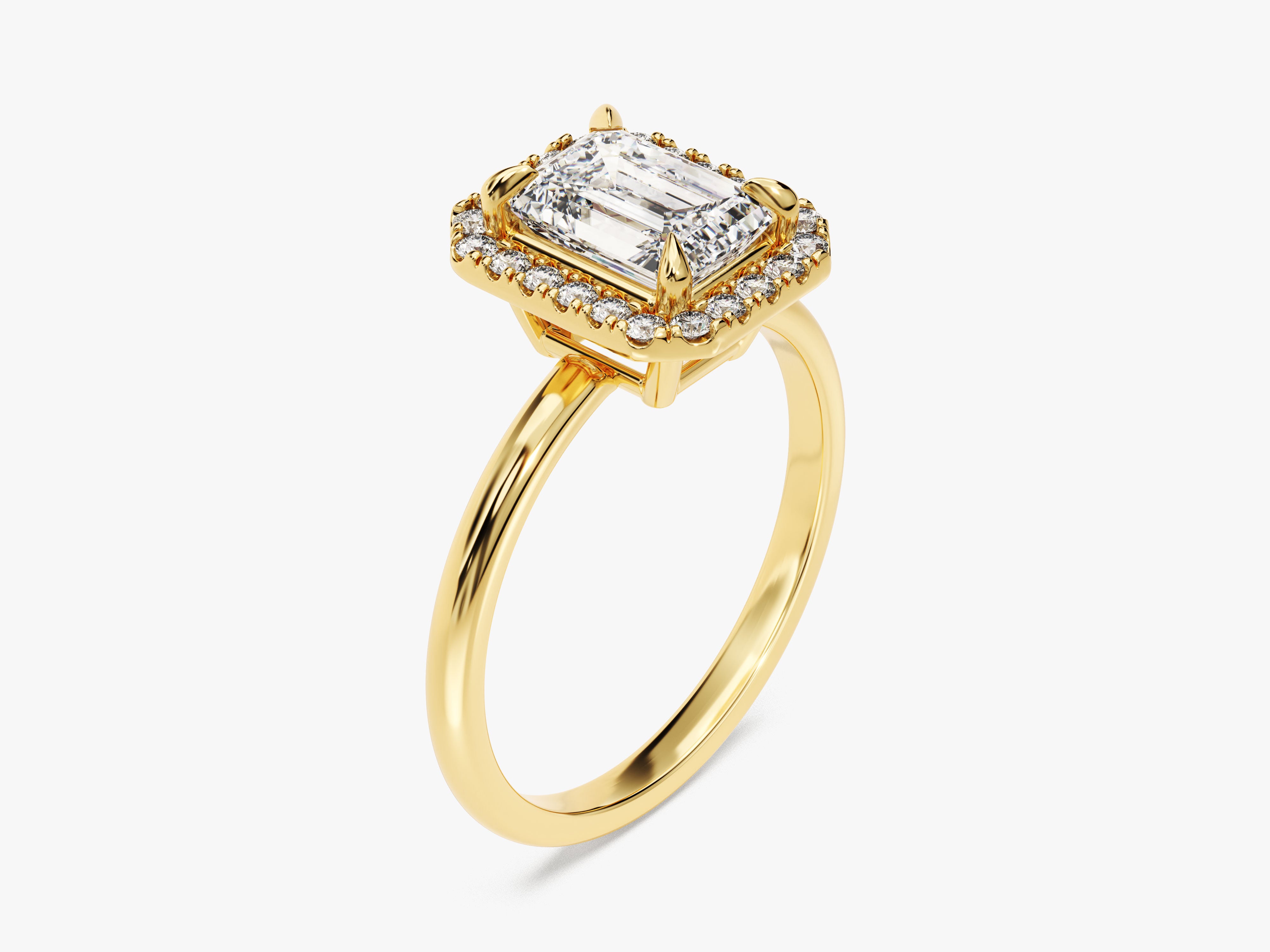 Emerald cut diamond halo engagement ring in yellow gold
