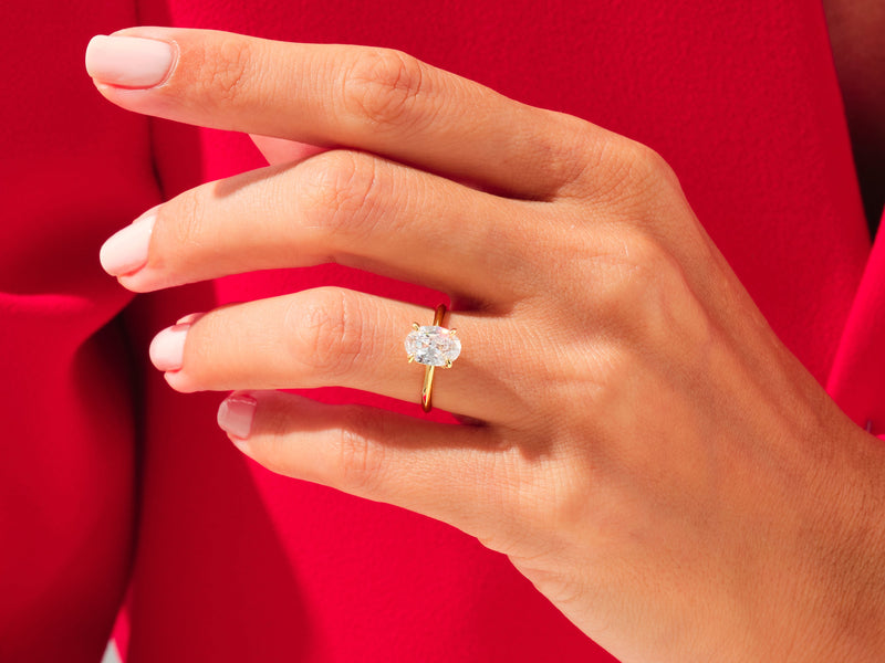 Oval diamond engagement ring on a hand