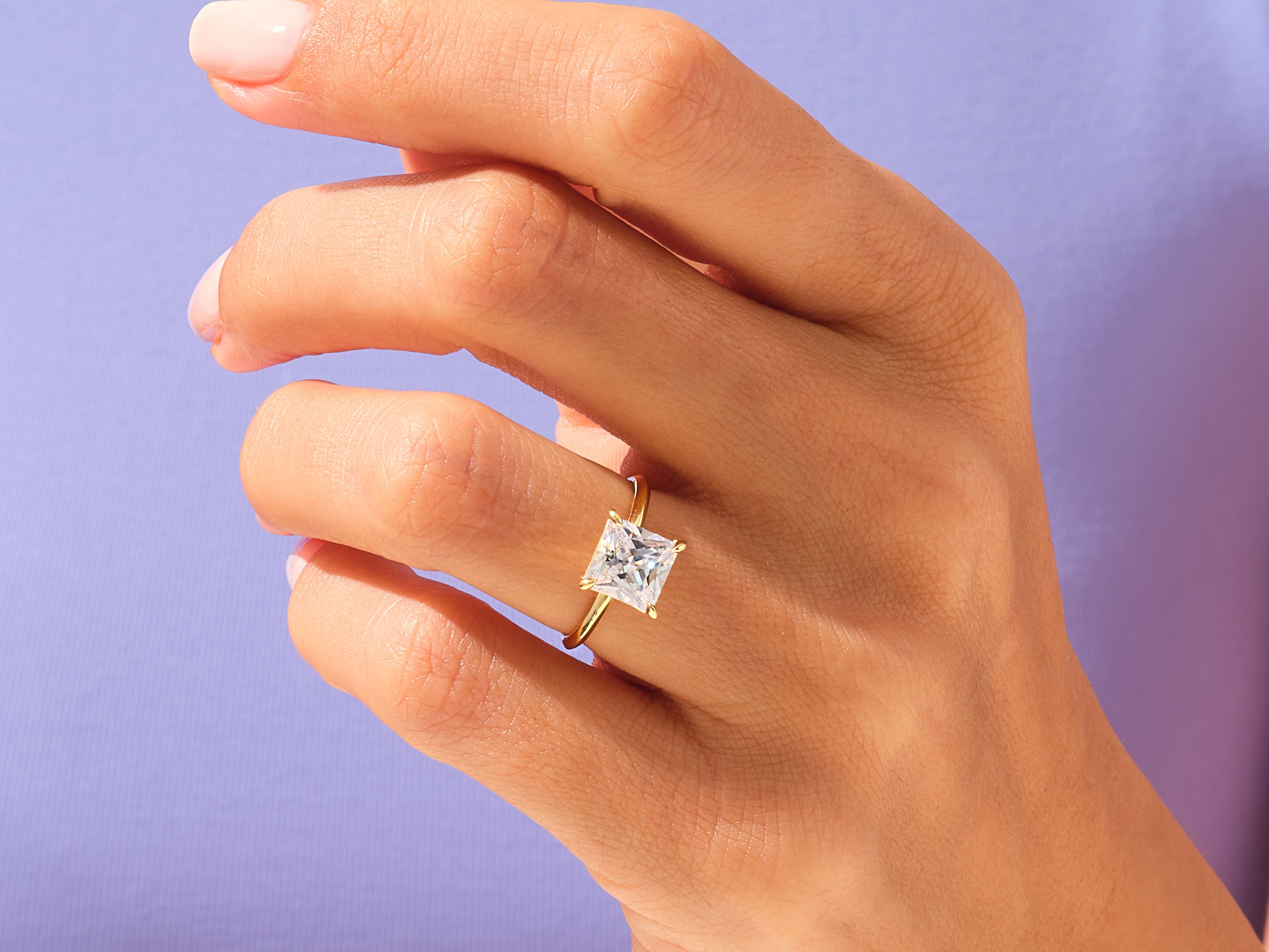 Princess cut diamond engagement ring on a woman's hand