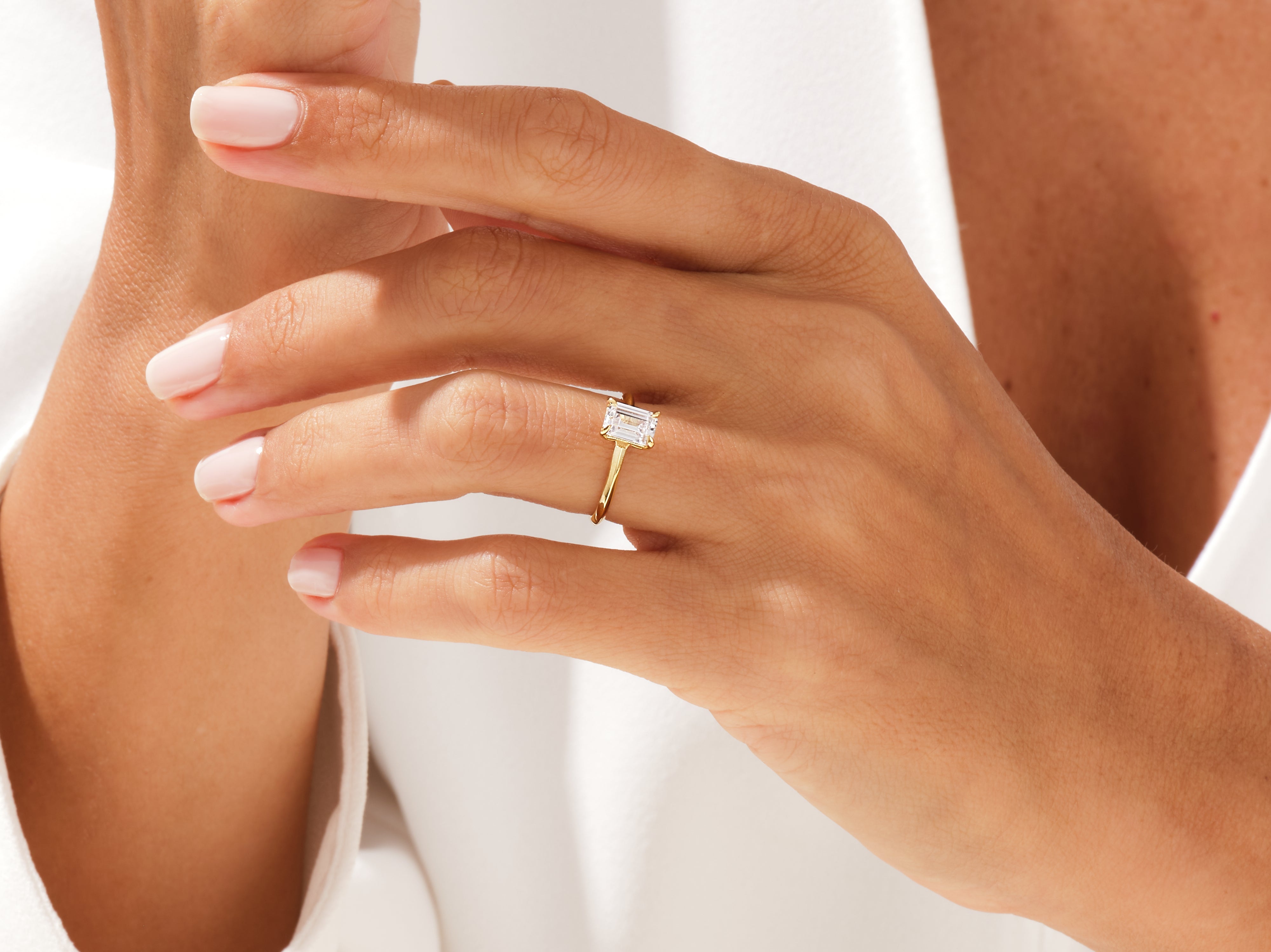 Emerald cut diamond ring on a woman's hand