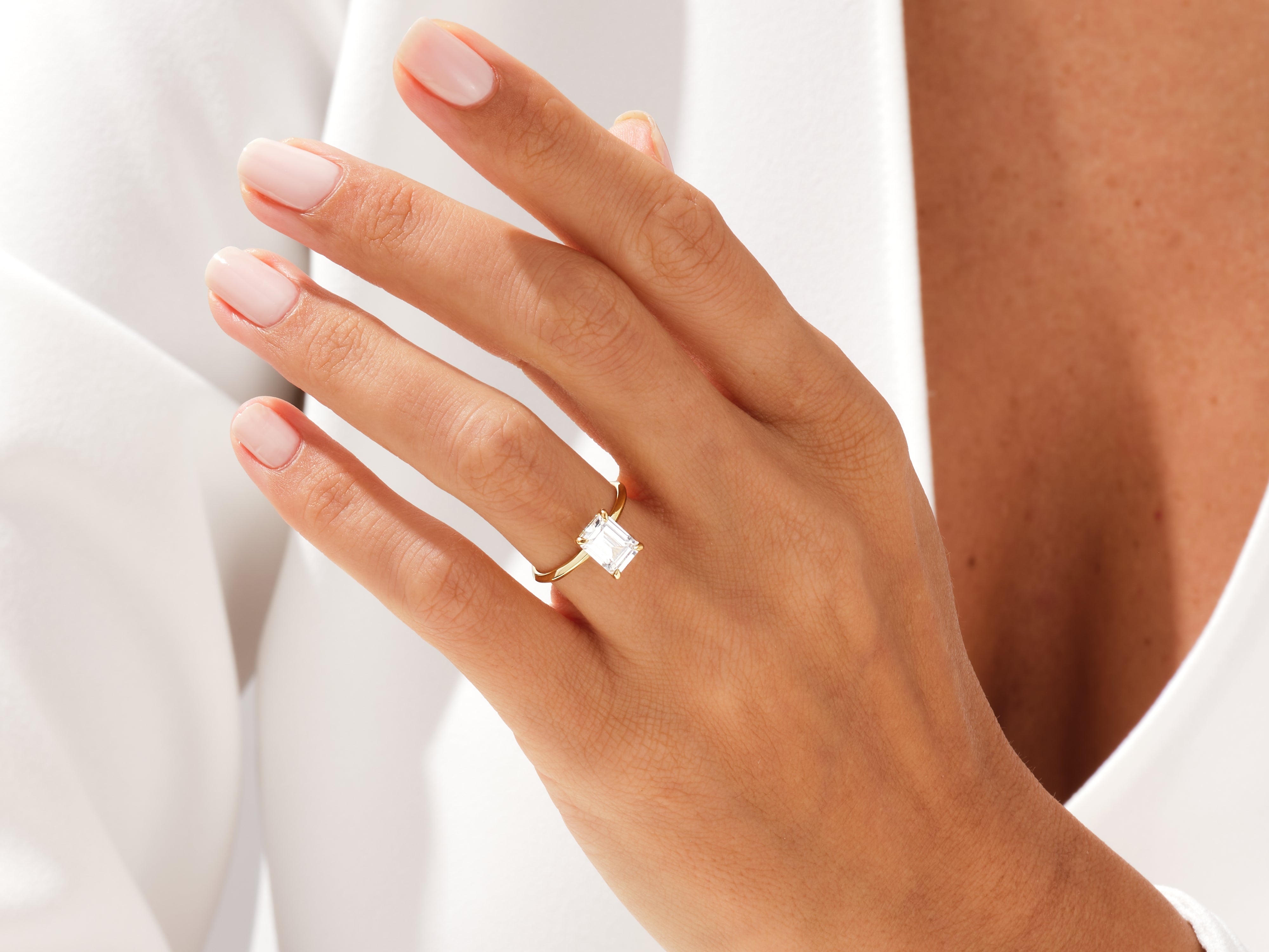 Emerald cut diamond ring on a woman's hand