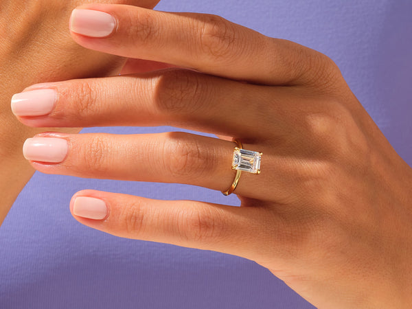 Emerald cut diamond ring on a woman's hand