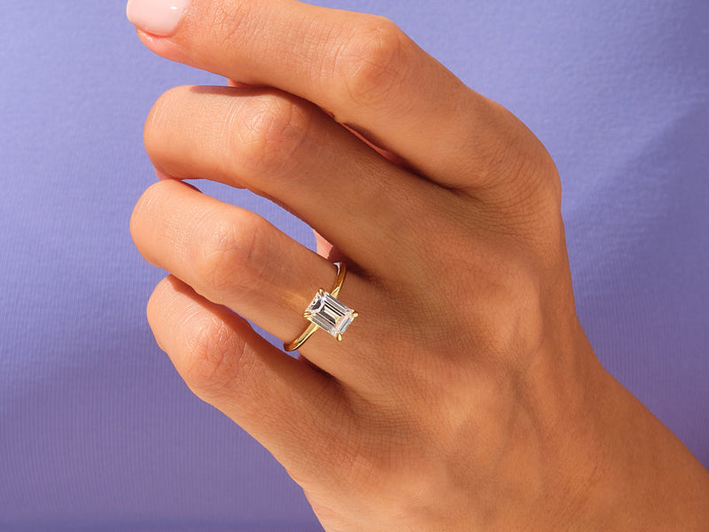 Emerald cut diamond ring on a hand, fine jewelry