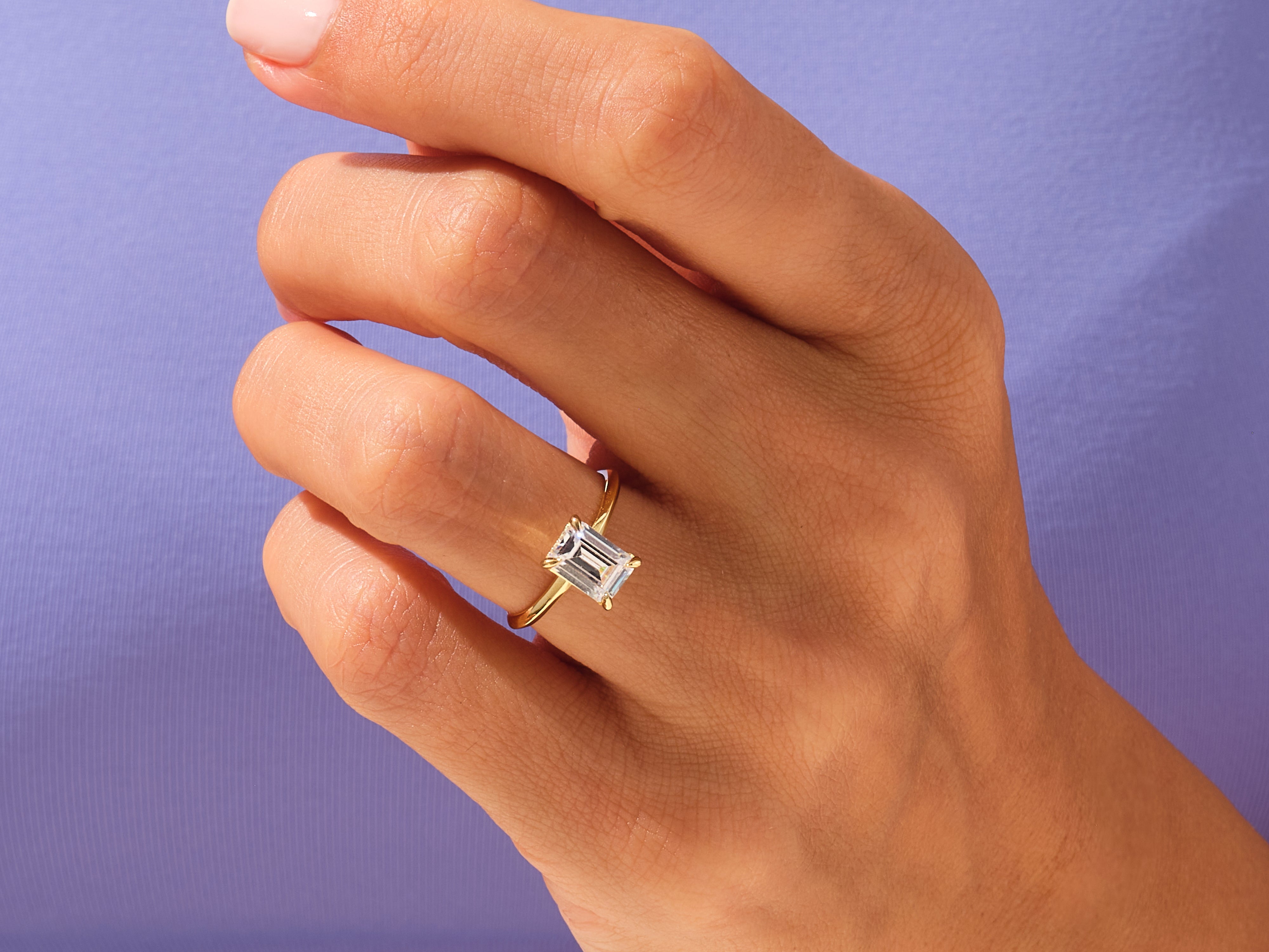 Emerald cut diamond ring on a hand, fine jewelry