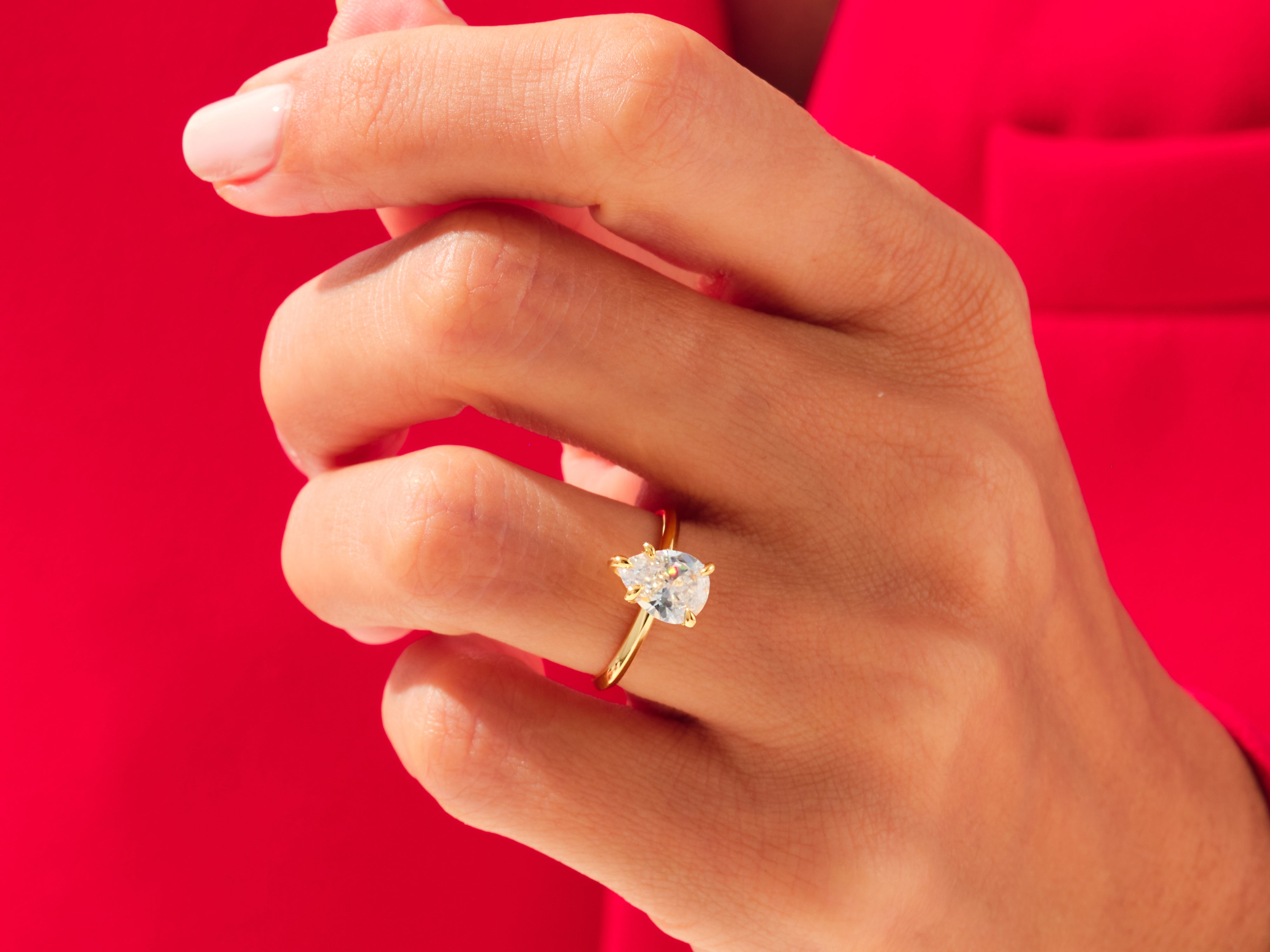 Pear cut diamond engagement ring on a hand, jewelry