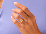 Gold ring with square cut diamond on woman's hand