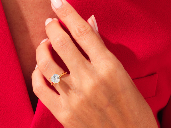 Heart-shaped diamond ring on a hand, jewelry